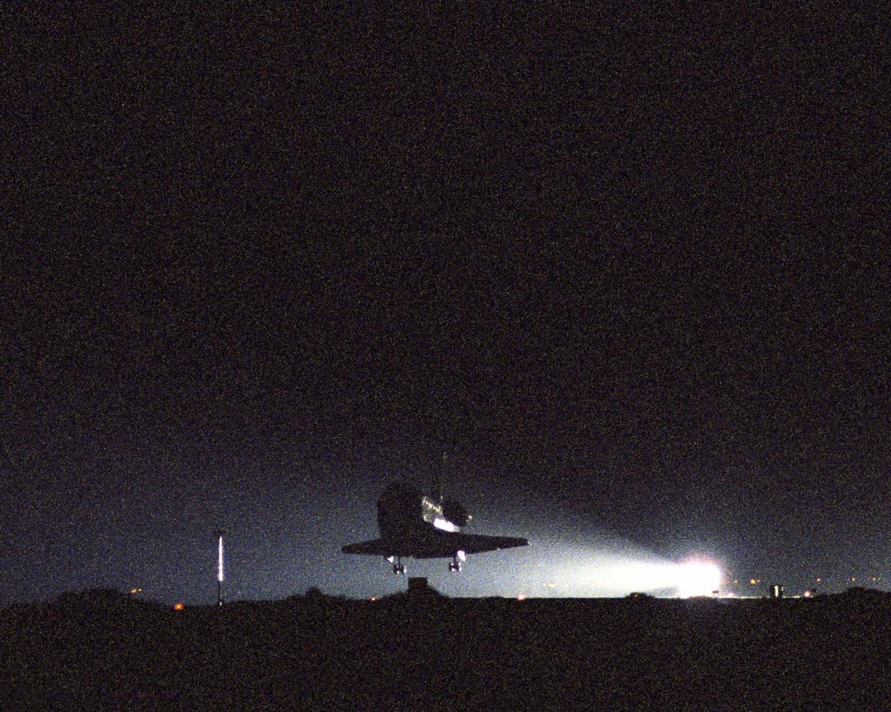 STS114-S-042 (9 August 2005) --- The Space Shuttle Discovery, with its crew of seven astronauts onboard, glides to a pre-dawn landing at Edwards Air Force Base in California. Touchdown occurred at 5:11 a.m. (PDT) August 9, 2005. Astronauts Eileen M. Collins and James M. Kelly, STS-114 commander and pilot, respectively, guided the ship as it made its 17,000 mph descent from space into the morning darkness. The landing concludes a historic 14-day, Return to Flight mission to the international space station. Also onboard were astronauts Stephen K. Robinson, Andrew S. W. Thomas, Wendy B. Lawrence, Charles J. Camarda, and Japan Aerospace Exploration Agency (JAXA) astronaut Soichi Noguchi, all mission specialists.