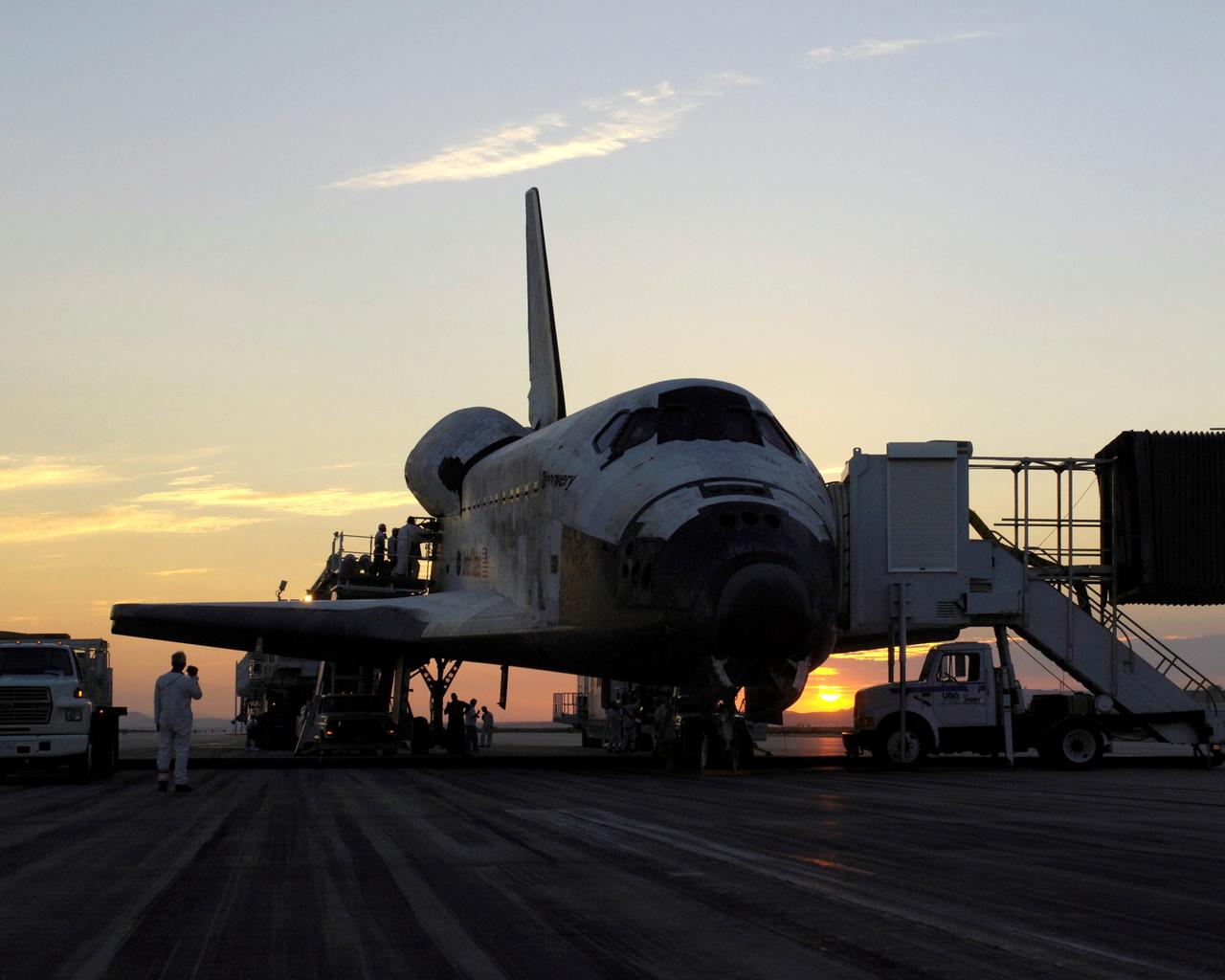 STS114-S-048 (9 August 2005) --- The sun rises on the Space Shuttle Discovery as it rests on the runway at Edwards Air Force Base in California, after a safe landing at 5:11 a.m. (PDT) on Aug. 9, 2005. The landing concludes a historic 14-day Return to Flight STS-114 mission to the international space station.