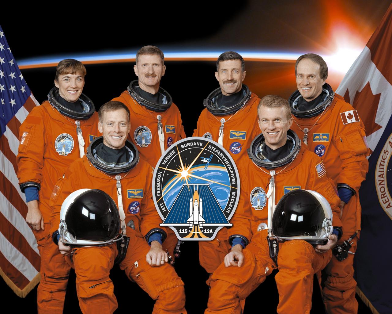 STS115-S-002 (8 November 2002) --- These six astronauts take a break from training to pose for the STS-115 crew portrait. Astronauts Brent W. Jett, Jr. (right) and Christopher J. Ferguson, commander and pilot, respectively, flank the mission insignia. The mission specialists are, from left to right, astronauts Heidemarie M. Stefanyshyn-Piper, Joseph R. (Joe) Tanner, Daniel C. Burbank, and Steven G. MacLean, who represents the Canadian Space Agency.