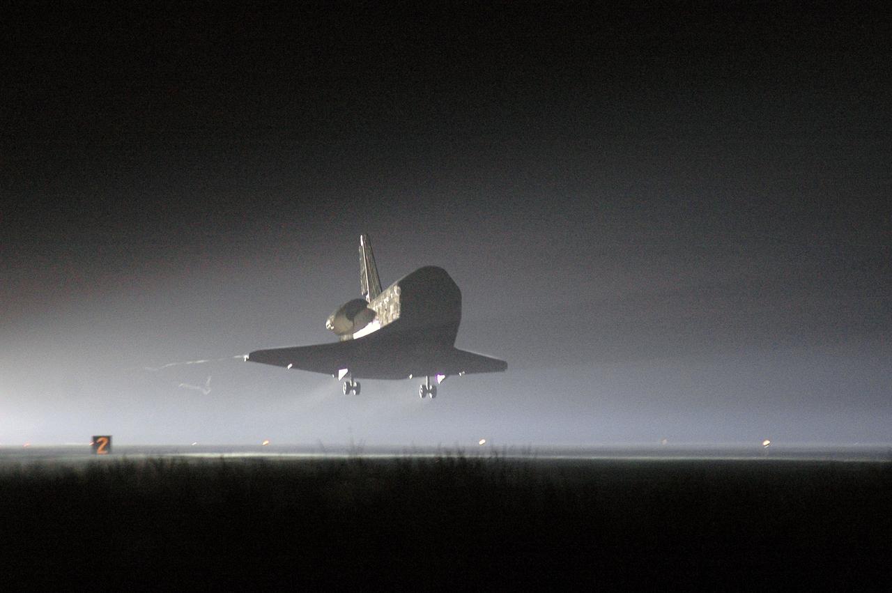 STS115-S-044 (21 Sept. 2006) --- Just before dawn, the Space Shuttle Atlantis' main landing gear is about to touch down on runway 33 at Kennedy Space Center's Shuttle Landing Facility. Landing occurred at 6:21:36 a.m. (EDT) on Sept. 21, 2006. Onboard were astronauts Brent W. Jett, Jr., STS-115 commander; Christopher J. Ferguson, pilot; Joseph R. Tanner, Daniel C. Burbank, Heidemarie M. Stefanyshyn-Piper, and Canadian Space Agency astronaut Steven G. MacLean, all mission specialists. The return of Atlantis concludes the successful nearly 12-day mission to resume construction of the International Space Station by installing the P3/P4 integrated truss and solar arrays.