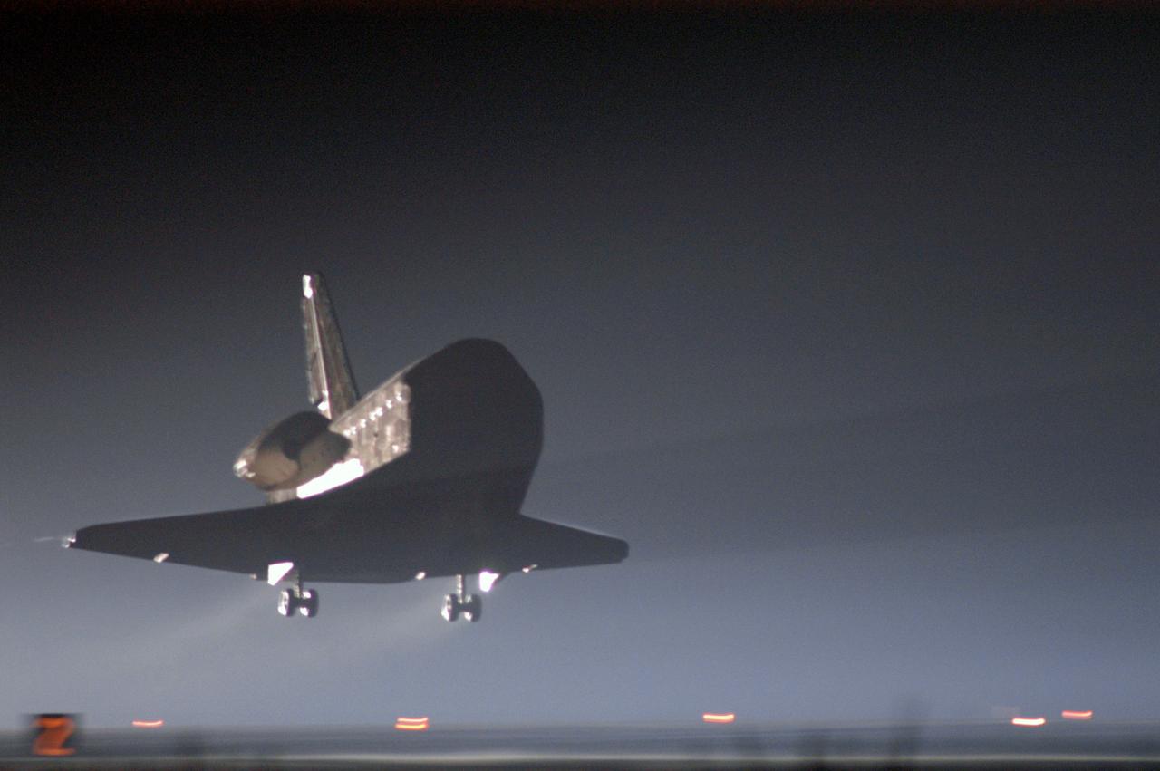 STS115-S-047 (21 Sept. 2006) --- Just before dawn, the Space Shuttle Atlantis' main landing gear is about to touch down on runway 33 at Kennedy Space Center's Shuttle Landing Facility. Landing occurred at 6:21:36 a.m. (EDT) on Sept. 21, 2006. Onboard were astronauts Brent W. Jett, Jr., STS-115 commander; Christopher J. Ferguson, pilot; Joseph R. Tanner, Daniel C. Burbank, Heidemarie M. Stefanyshyn-Piper, and Canadian Space Agency astronaut Steven G. MacLean, all mission specialists. The return of Atlantis concludes the successful nearly 12-day mission to resume construction of the International Space Station by installing the P3/P4 integrated truss and solar arrays.