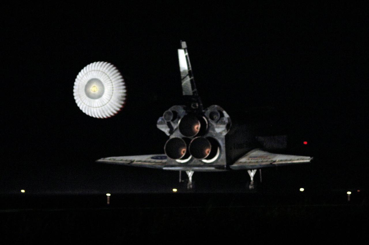 STS115-S-051 (21 Sept. 2006) --- With drag chute deployed, Space Shuttle Atlantis slows to a stop after landing on runway 33 at Kennedy Space Center's Shuttle Landing Facility at 6:21:36 a.m. (EDT) on Sept. 21, 2006. Onboard were astronauts Brent W. Jett, Jr., STS-115 commander; Christopher J. Ferguson, pilot; Joseph R. Tanner, Daniel C. Burbank, Heidemarie M. Stefanyshyn-Piper, and Canadian Space Agency astronaut Steven G. MacLean, all mission specialists. The return of Atlantis concludes the successful nearly 12-day mission to resume construction of the International Space Station by installing the P3/P4 integrated truss and solar arrays.