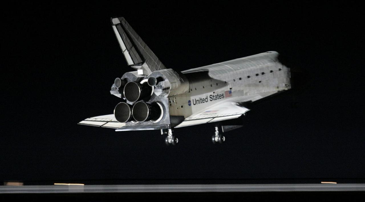 STS115-S-052 (21 Sept. 2006) --- Just before dawn, the Space Shuttle Atlantis' main landing gear is about to touch down on runway 33 at Kennedy Space Center's Shuttle Landing Facility. Landing occurred at 6:21:36 a.m. (EDT) on Sept. 21, 2006. Onboard were astronauts Brent W. Jett, Jr., STS-115 commander; Christopher J. Ferguson, pilot; Joseph R. Tanner, Daniel C. Burbank, Heidemarie M. Stefanyshyn-Piper, and Canadian Space Agency astronaut Steven G. MacLean, all mission specialists. The return of Atlantis concludes the successful nearly 12-day mission to resume construction of the International Space Station by installing the P3/P4 integrated truss and solar arrays.