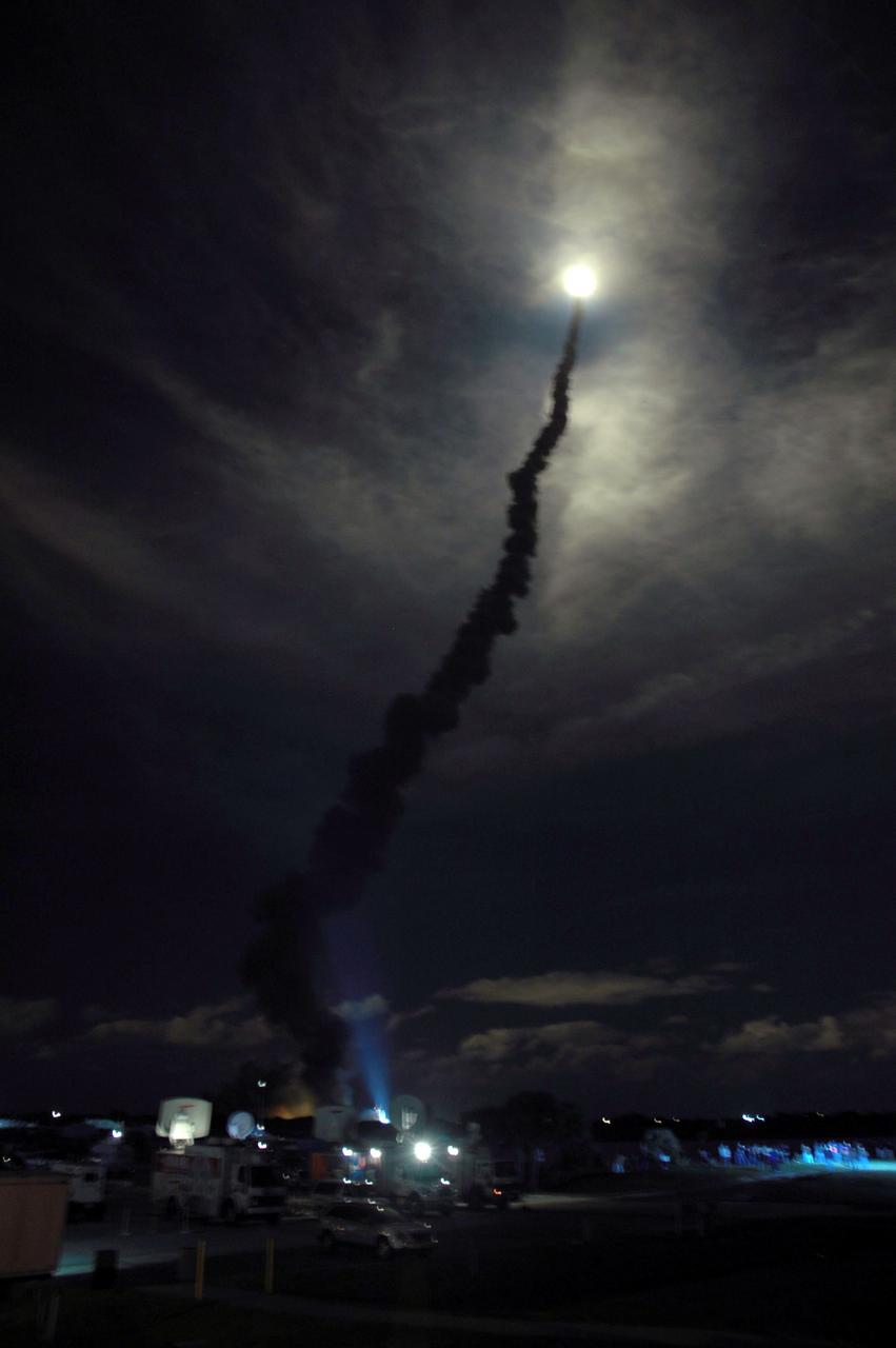 STS116-S-009 (9 Dec. 2006) --- Against a black night sky, the Space Shuttle Discovery and its seven-member crew head toward Earth-orbit and a scheduled link-up with the International Space Station. Liftoff from the Kennedy Space Center's launch pad 39B occurred at 8:47 p.m. (EST) on Dec. 9, 2006 in what was the first evening shuttle launch since 2002. The STS-116 crew will link up with the station on Monday, Dec. 11, to begin a complex, week-long stay that will rewire the outpost and increase its power supply. During three spacewalks and intricate choreography with ground controllers, the astronauts will bring electrical power on line generated by a giant solar array wing delivered to the station in September.