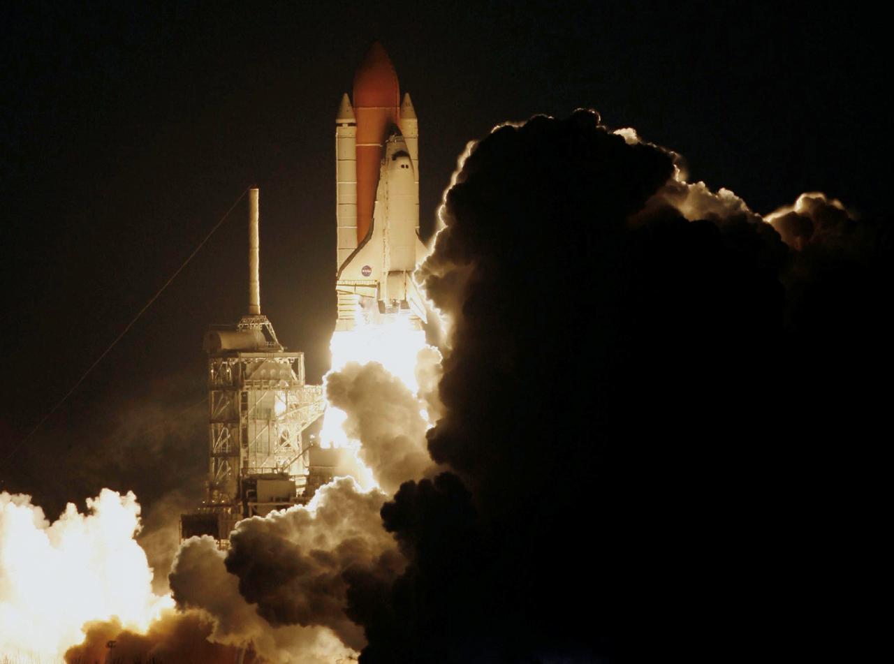 STS116-S-010 (9 Dec. 2006) --- Against a black night sky, the Space Shuttle Discovery and its seven-member crew head toward Earth-orbit and a scheduled link-up with the International Space Station. Liftoff from the Kennedy Space Center's launch pad 39B occurred at 8:47 p.m. (EST) on Dec. 9, 2006 in what was the first evening shuttle launch since 2002. The STS-116 crew will link up with the station on Monday, Dec. 11, to begin a complex, week-long stay that will rewire the outpost and increase its power supply. During three spacewalks and intricate choreography with ground controllers, the astronauts will bring electrical power on line generated by a giant solar array wing delivered to the station in September.