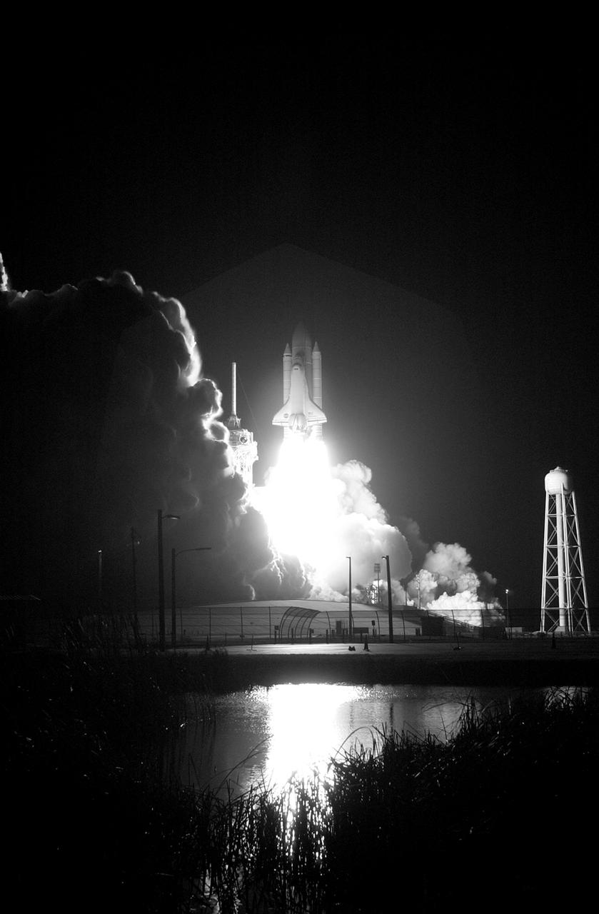 STS116-S-016 (9 Dec. 2006) --- Against a black night sky, the Space Shuttle Discovery and its seven-member crew head toward Earth-orbit and a scheduled link-up with the International Space Station. Liftoff from the Kennedy Space Center's launch pad 39B occurred at 8:47 p.m. (EST) on Dec. 9, 2006 in what was the first evening shuttle launch since 2002. The STS-116 crew will link up with the station on Monday, Dec. 11, to begin a complex, week-long stay that will rewire the outpost and increase its power supply. During three spacewalks and intricate choreography with ground controllers, the astronauts will bring electrical power on line generated by a giant solar array wing delivered to the station in September.