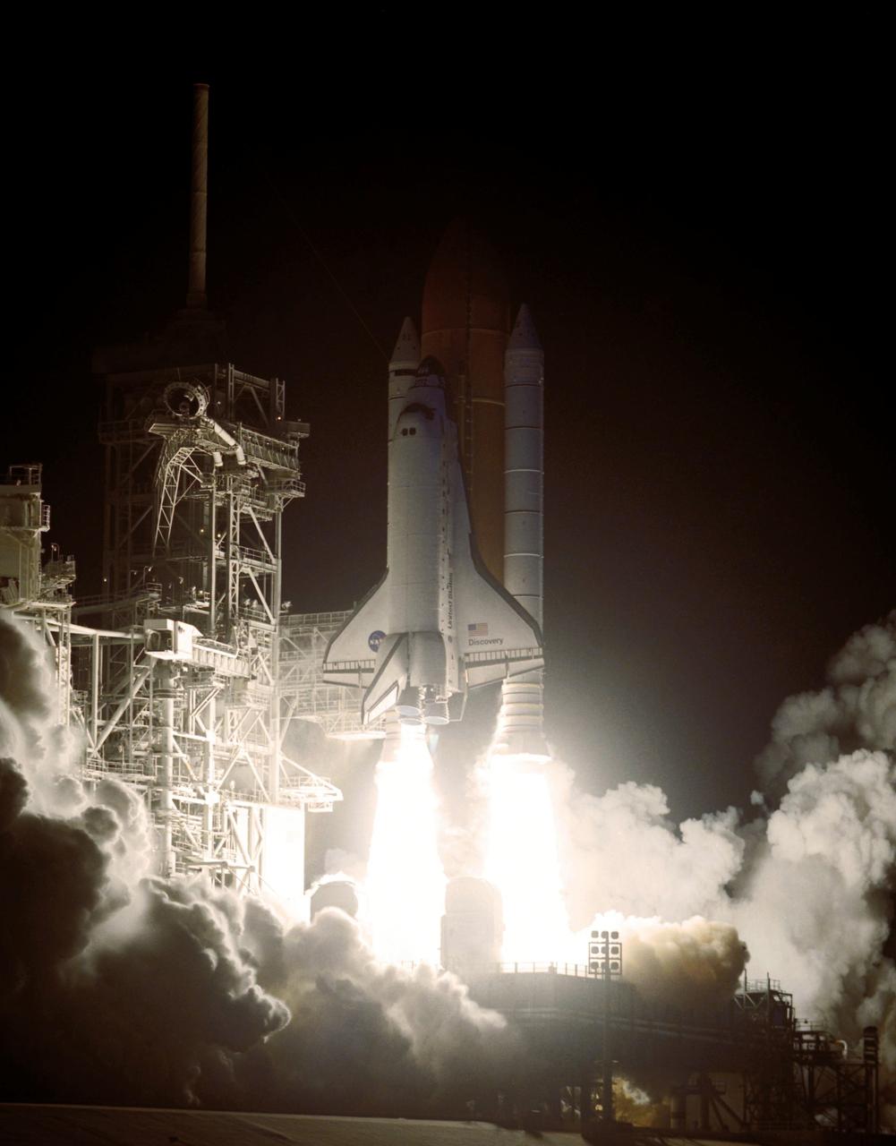 STS116-S-023 (9 Dec. 2006) --- Against a black night sky, the Space Shuttle Discovery and its seven-member crew head toward Earth-orbit and a scheduled link-up with the International Space Station. Liftoff from the Kennedy Space Center's launch pad 39B occurred at 8:47 p.m. (EST) on Dec. 9, 2006 in what was the first evening shuttle launch since 2002. The STS-116 crew will link up with the station on Monday, Dec. 11, to begin a complex, week-long stay that will rewire the outpost and increase its power supply. During three spacewalks and intricate choreography with ground controllers, the astronauts will bring electrical power on line generated by a giant solar array wing delivered to the station in September.