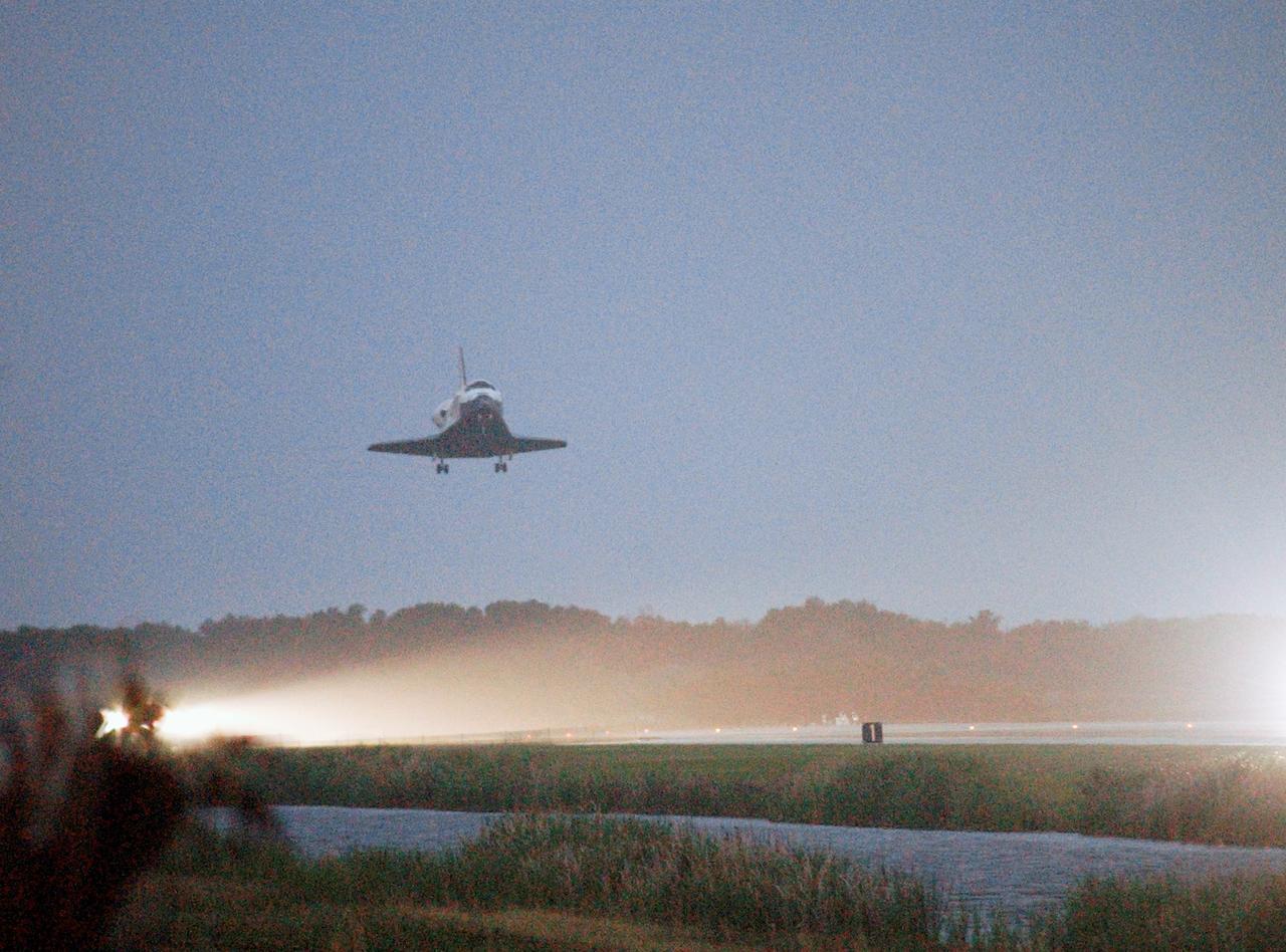 STS116-S-062 (22 Dec. 2006) --- A low angle view shows Discovery approaching Runway 15 at NASA Kennedy Space Center's Shuttle Landing Facility, concluding mission STS-116. Aboard are astronauts Mark L. Polansky, commander; William A. Oefelein, pilot; and Robert L. Curbeam Jr., Joan E. Higginbotham, Nicholas J.M. Patrick and European Space Agency astronauts Christer Fuglesang and Thomas Reiter--all mission specialists. Reiter is returning from a six-month stay on the International Space Station. During the mission, three spacewalks attached the P5 integrated truss structure to the station, and completed the rewiring of the orbiting laboratory's power system. A contingency spacewalk was added to retract a stubborn solar array. Main gear touchdown was at 5:32 p.m. (EST). Nose gear touchdown was at 5:32:12 p.m. and wheel stop was at 5:32:52 p.m. At touchdown -- nominally about 2,500 ft. beyond the runway threshold -- the orbiter is traveling at a speed ranging from 213 to 226 mph. Discovery traveled 5,330,000 miles, landing on orbit 204. Mission elapsed time was 12 days, 20 hours, 44 minutes and 16 seconds. This is the 64th landing at KSC.