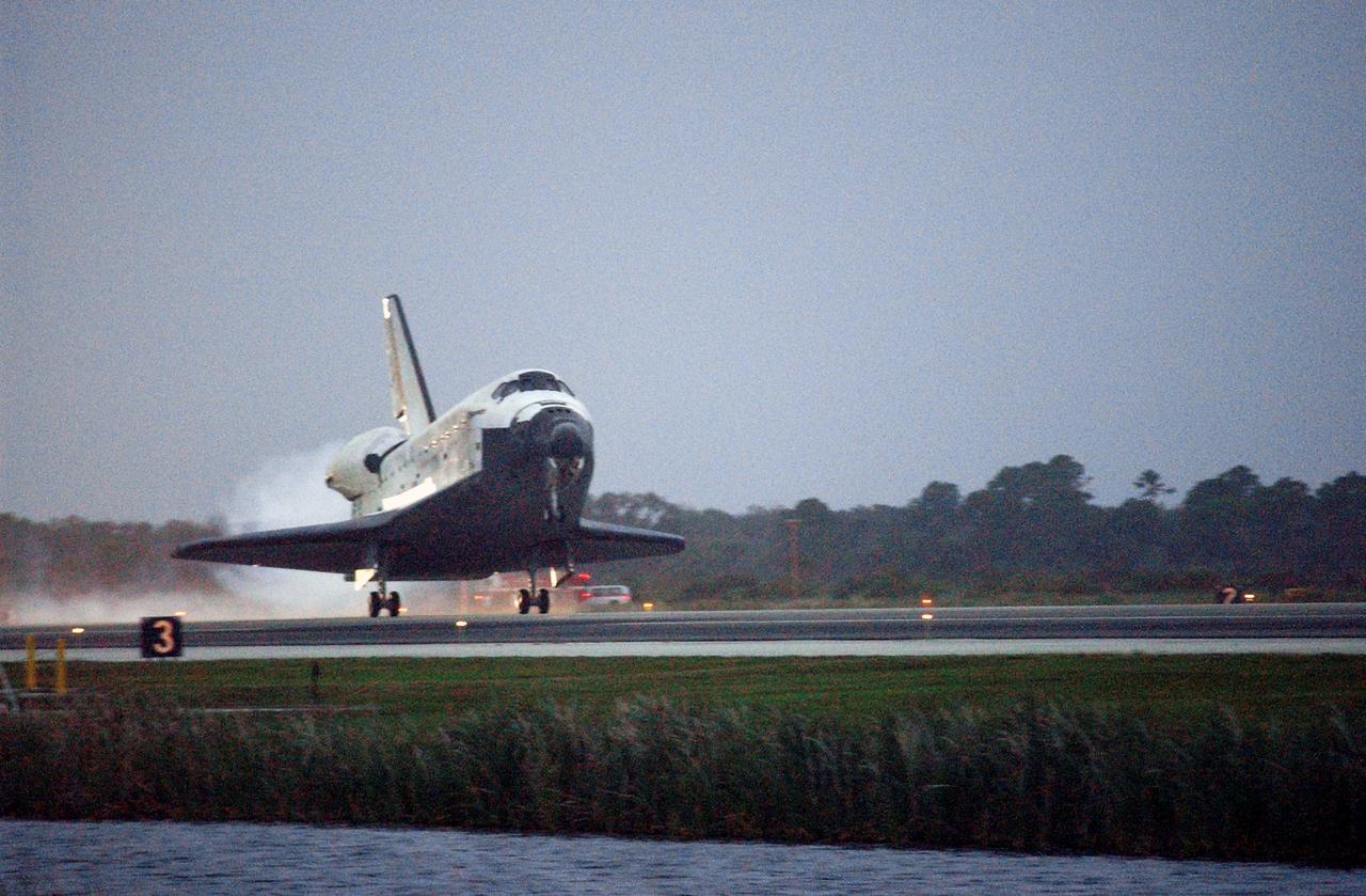 STS116-S-064 (22 Dec. 2006) --- Discovery's main landing gear touches down on Runway 15 at NASA Kennedy Space Center's Shuttle Landing Facility, concluding mission STS-116. Aboard are astronauts Mark L. Polansky, commander; William A. Oefelein, pilot; and Robert L. Curbeam Jr., Joan E. Higginbotham, Nicholas J.M. Patrick and European Space Agency astronauts Christer Fuglesang and Thomas Reiter--all mission specialists. Reiter is returning from a six-month stay on the International Space Station. During the mission, three spacewalks attached the P5 integrated truss structure to the station, and completed the rewiring of the orbiting laboratory's power system. A contingency spacewalk was added to retract a stubborn solar array. Main gear touchdown was at 5:32 p.m. (EST). Nose gear touchdown was at 5:32:12 p.m. and wheel stop was at 5:32:52 p.m. At touchdown -- nominally about 2,500 ft. beyond the runway threshold -- the orbiter is traveling at a speed ranging from 213 to 226 mph. Discovery traveled 5,330,000 miles, landing on orbit 204. Mission elapsed time was 12 days, 20 hours, 44 minutes and 16 seconds. This is the 64th landing at KSC.