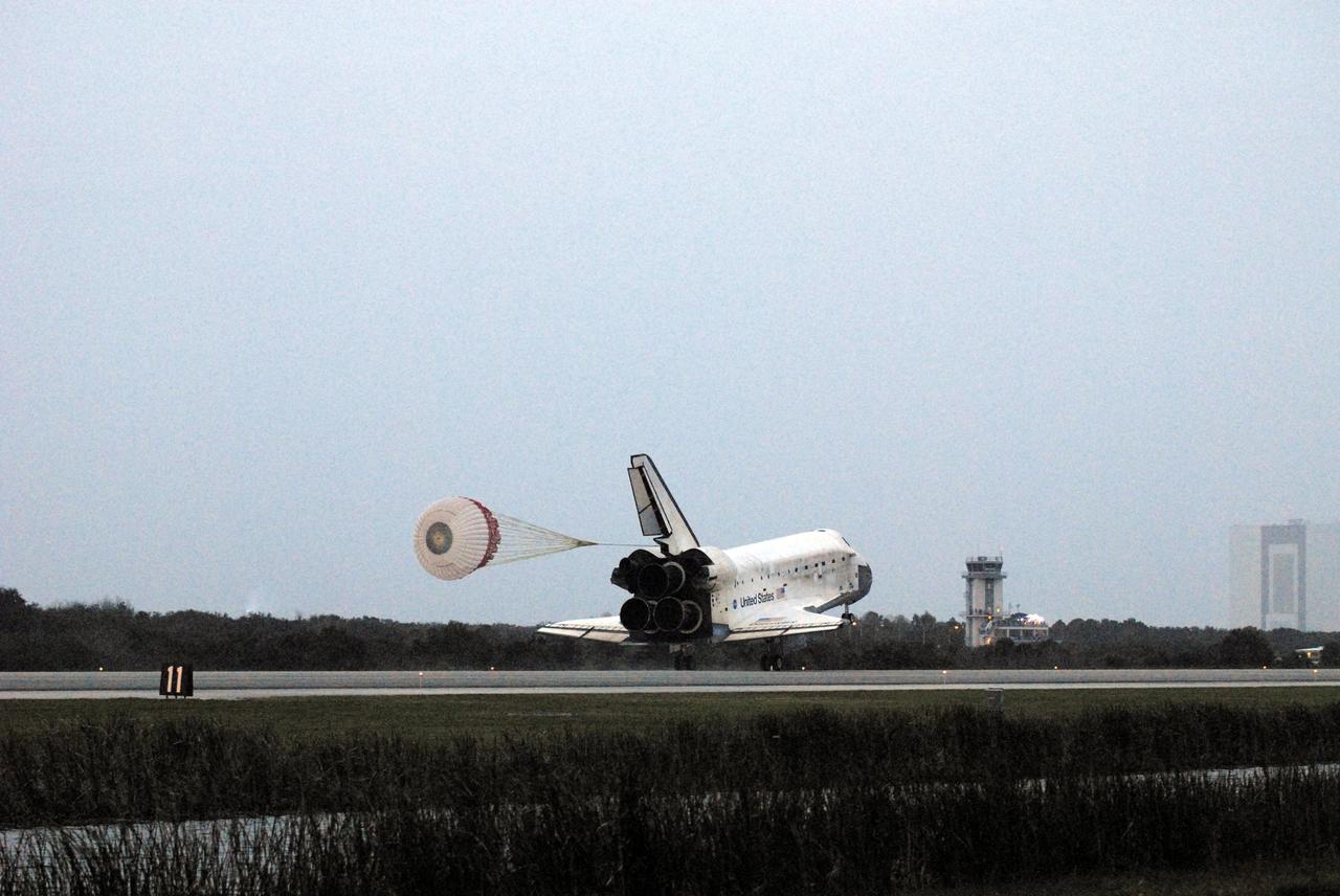STS116-S-071 (22 Dec. 2006) --- Discovery's drag chute is fully deployed as the spacecraft rolls toward wheels stop on Runway 15 at NASA Kennedy Space Center's Shuttle Landing Facility , concluding mission STS-116. The Vehicle Assembly Building can be seen at far right. Aboard are astronauts Mark L. Polansky, commander; William A. Oefelein, pilot; and Robert L. Curbeam Jr., Joan E. Higginbotham, Nicholas J.M. Patrick and European Space Agency astronauts Christer Fuglesang and Thomas Reiter--all mission specialists. Reiter is returning from a six-month stay on the International Space Station. During the mission, three spacewalks attached the P5 integrated truss structure to the station, and completed the rewiring of the orbiting laboratory's power system. A contingency spacewalk was added to retract a stubborn solar array. Main gear touchdown was at 5:32 p.m. (EST). Nose gear touchdown was at 5:32:12 p.m. and wheel stop was at 5:32:52 p.m. At touchdown -- nominally about 2,500 ft. beyond the runway threshold -- the orbiter is traveling at a speed ranging from 213 to 226 mph. Discovery traveled 5,330,000 miles, landing on orbit 204. Mission elapsed time was 12 days, 20 hours, 44 minutes and 16 seconds. This is the 64th landing at KSC.