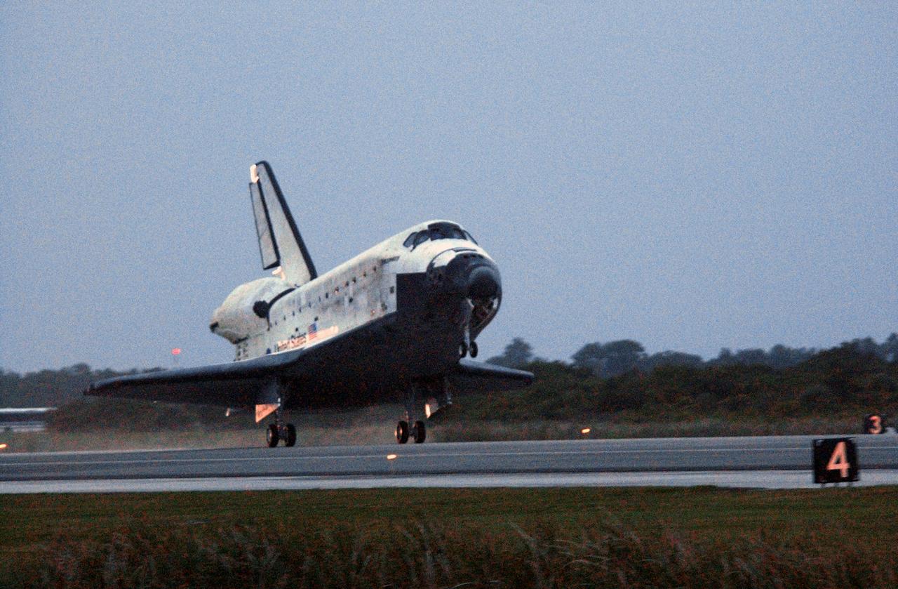 STS116-S-072 (22 Dec. 2006) --- As the sun sets, Discovery's main landing gear touches down on Runway 15 at NASA Kennedy Space Center's Shuttle Landing Facility, concluding mission STS-116. Aboard are astronauts Mark L. Polansky, commander; William A. Oefelein, pilot; and Robert L. Curbeam Jr., Joan E. Higginbotham, Nicholas J.M. Patrick and European Space Agency astronauts Christer Fuglesang and Thomas Reiter--all mission specialists. Reiter is returning from a six-month stay on the International Space Station. During the mission, three spacewalks attached the P5 integrated truss structure to the station, and completed the rewiring of the orbiting laboratory's power system. A contingency spacewalk was added to retract a stubborn solar array. Main gear touchdown was at 5:32 p.m. (EST). Nose gear touchdown was at 5:32:12 p.m. and wheel stop was at 5:32:52 p.m. At touchdown -- nominally about 2,500 ft. beyond the runway threshold -- the orbiter is traveling at a speed ranging from 213 to 226 mph. Discovery traveled 5,330,000 miles, landing on orbit 204. Mission elapsed time was 12 days, 20 hours, 44 minutes and 16 seconds. This is the 64th landing at KSC.