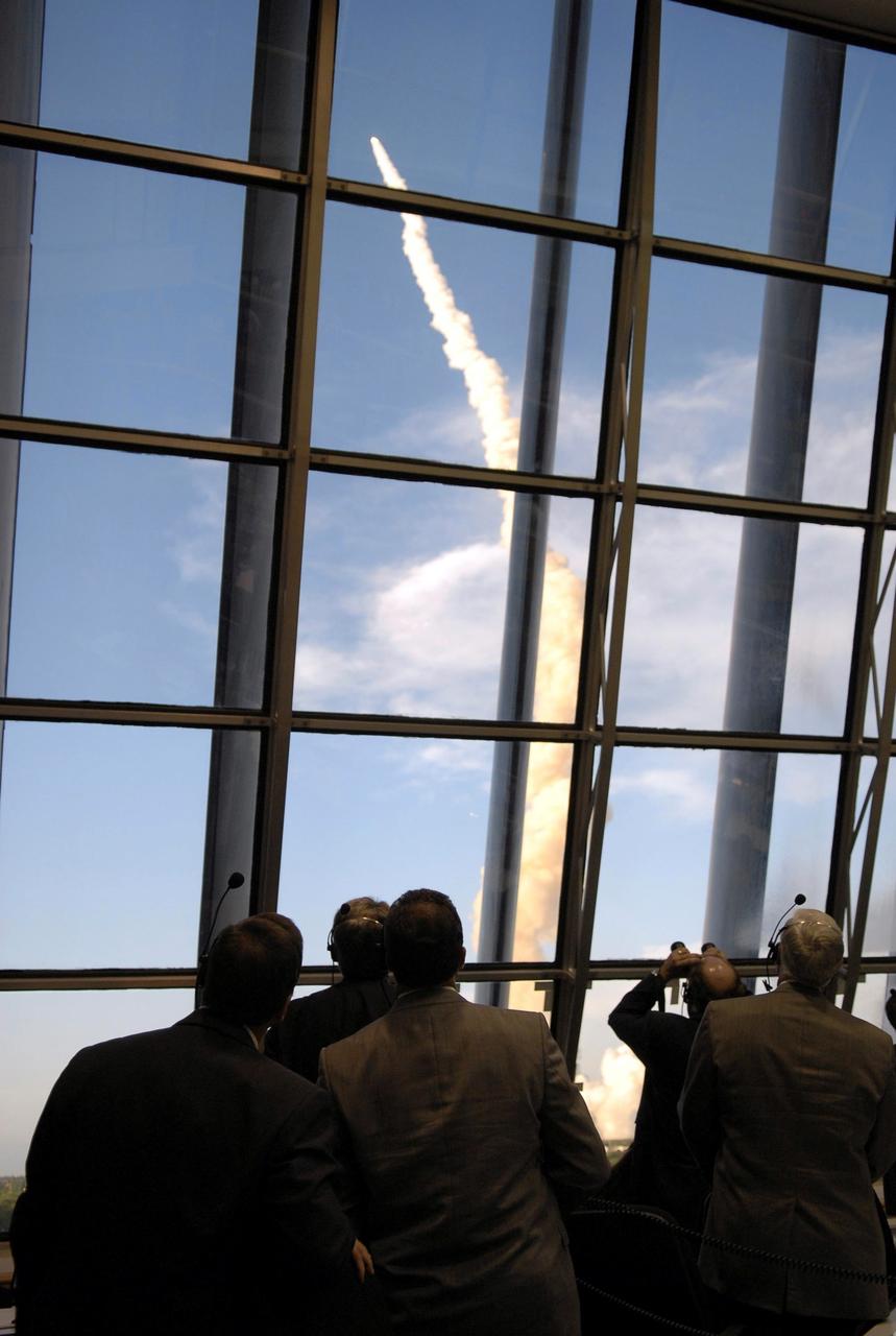 STS117-S-014 (8 June 2007) --- Through the large windows in the Launch Control Center, NASA officials watch the launch of Space Shuttle Atlantis on mission STS-117. Atlantis and its seven-member crew head toward Earth-orbit and a scheduled link-up with the International Space Station. Liftoff from Kennedy Space Center's launch pad 39A occurred at 7:38 p.m. (EDT) on June 8, 2007. Onboard are astronauts Rick Sturckow, commander; Lee Archambault, pilot; Jim Reilly, Patrick Forrester, John "Danny" Olivas, Steven Swanson and Clayton Anderson, all mission specialists. Anderson will join Expedition 15 in progress to serve as a flight engineer aboard the station. Atlantis will dock with the orbital outpost on Sunday, June 10, to begin a joint mission that will increase the complex's power generation capability. Using the shuttle and station robotic arms and conducting three scheduled spacewalks, the astronauts will install another set of giant solar array wings on the station and retract another array, preparing it for a future move.