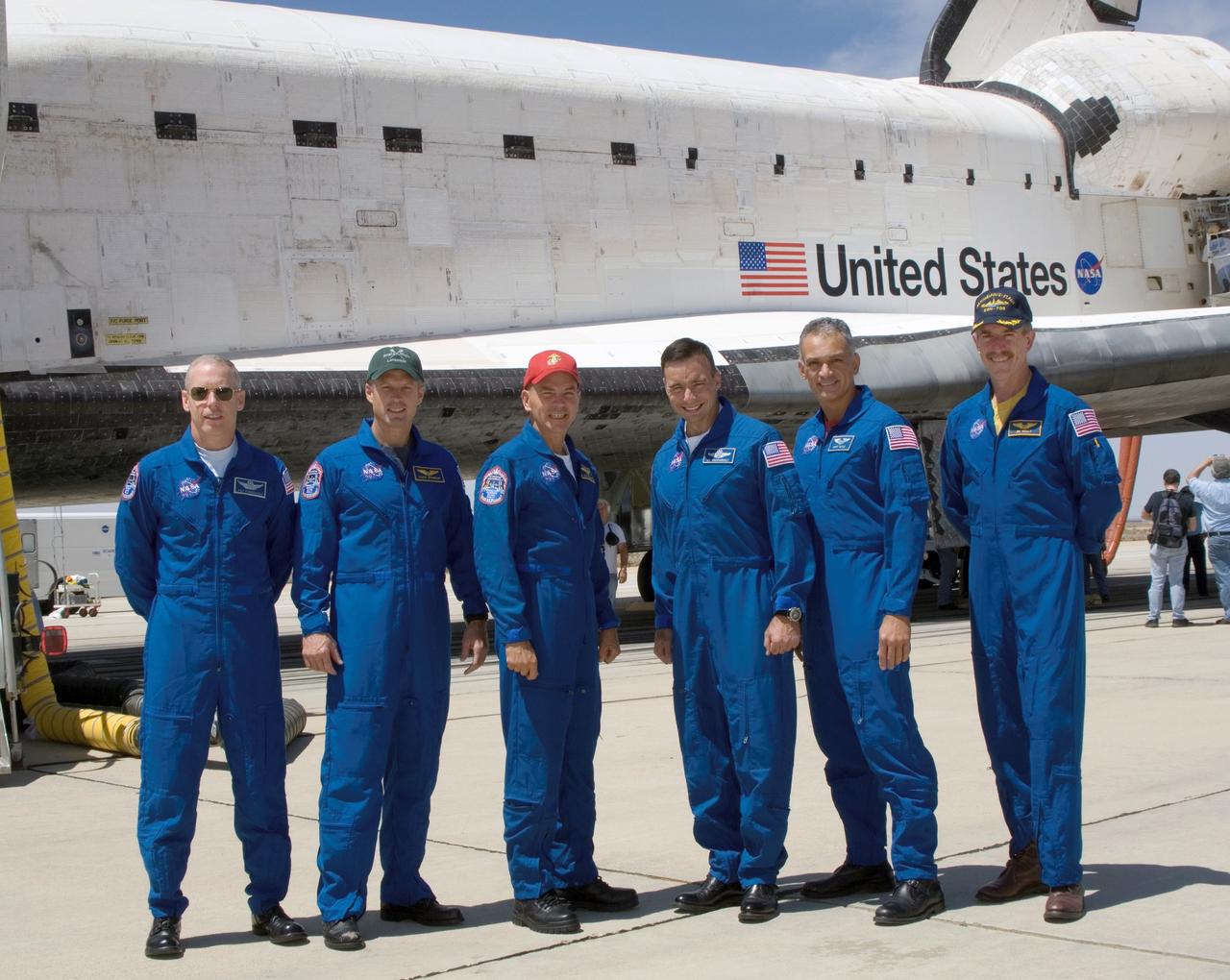 STS117-S-052 (22 June 2007) --- The STS-117 crew poses in front of the Space Shuttle Atlantis after a successful landing at 12:49 p.m. (PDT) on June 22, 2007 at Edwards Air Force Base in California. From the left are astronauts Patrick Forrester, Steven Swanson, both mission specialists; Rick Sturckow, commander; Lee Archambault, pilot; John "Danny" Olivas and Jim Reilly, both mission specialists.