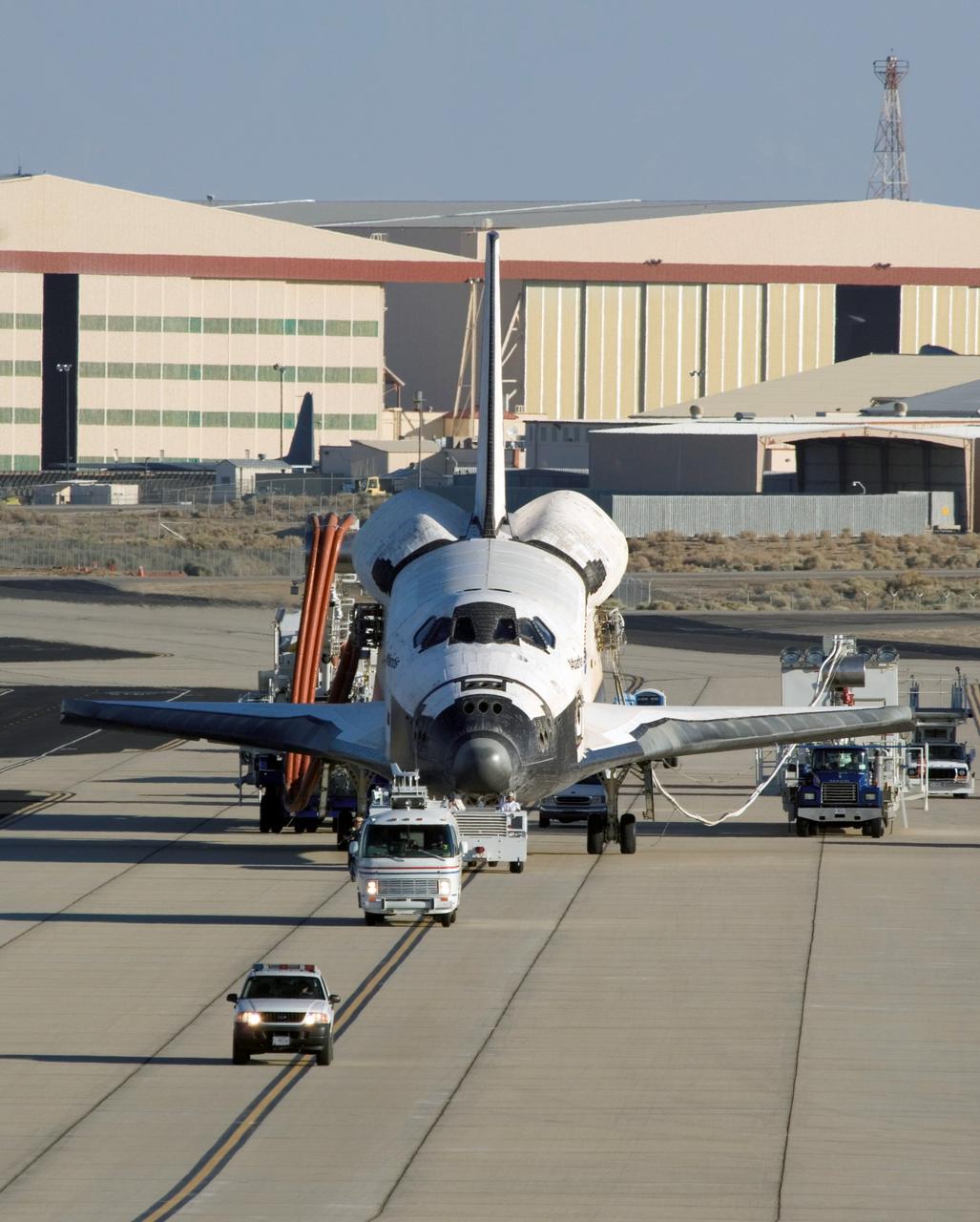 STS117-S-053 (22 June 2007) --- Accompanied by a convoy of recovery vehicles, the Space Shuttle Atlantis is towed up the taxiway at NASA Dryden Flight Research Center following a successful landing at 12:49 p.m. (PDT) on June 22, 2007 at Edwards Air Force Base in California.