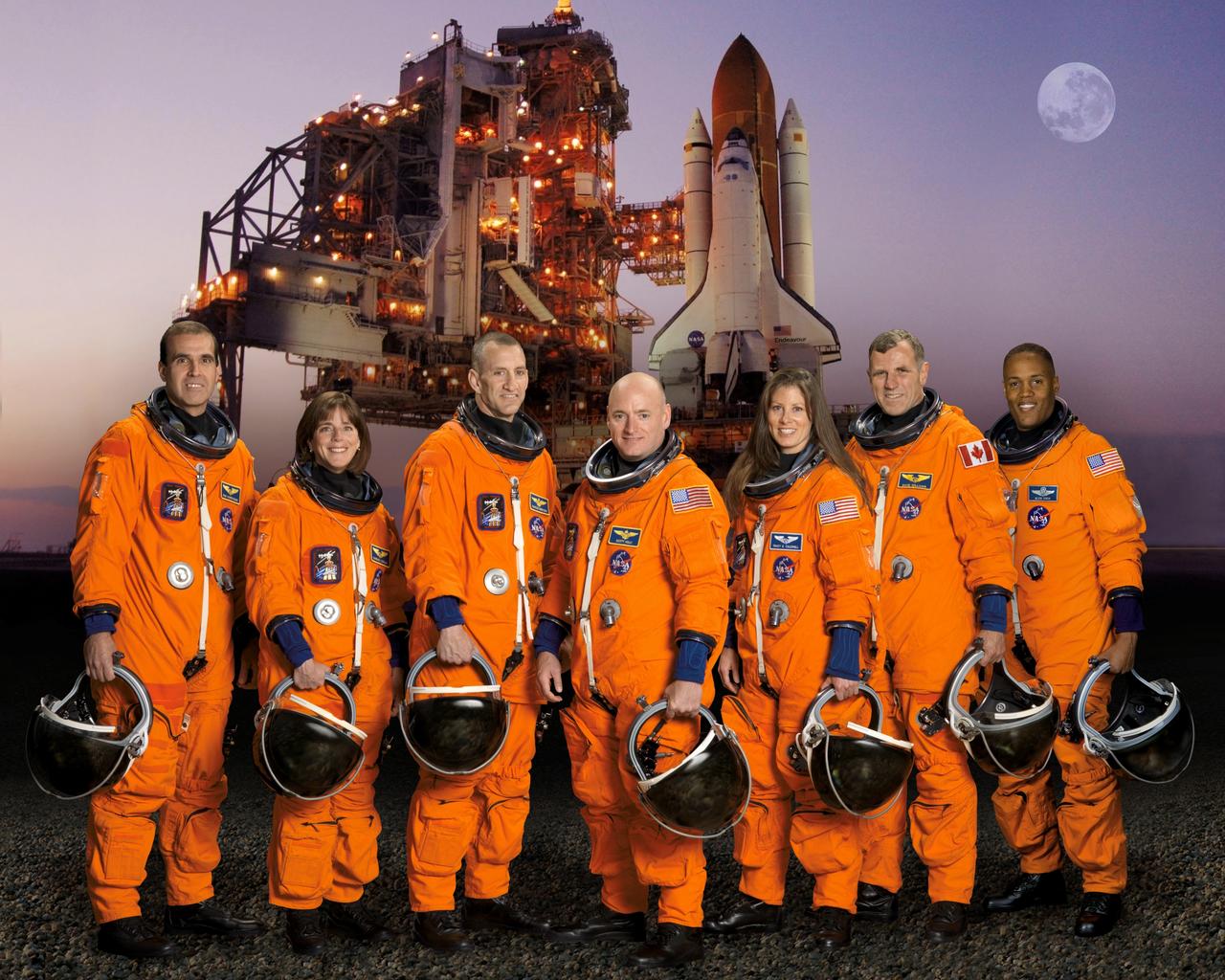 STS118-S-002 (May 2007) --- These seven astronauts take a break from training to pose for the STS-118 crew portrait. Pictured from the left are astronauts Richard A. (Rick) Mastracchio, mission specialist; Barbara R. Morgan, mission specialist; Charles O. Hobaugh, pilot; Scott J. Kelly, commander; Tracy E. Caldwell, Canadian Space Agency's Dafydd R. (Dave) Williams, and Alvin Drew Jr., all mission specialists. The crewmembers are attired in training versions of their shuttle launch and entry suits.