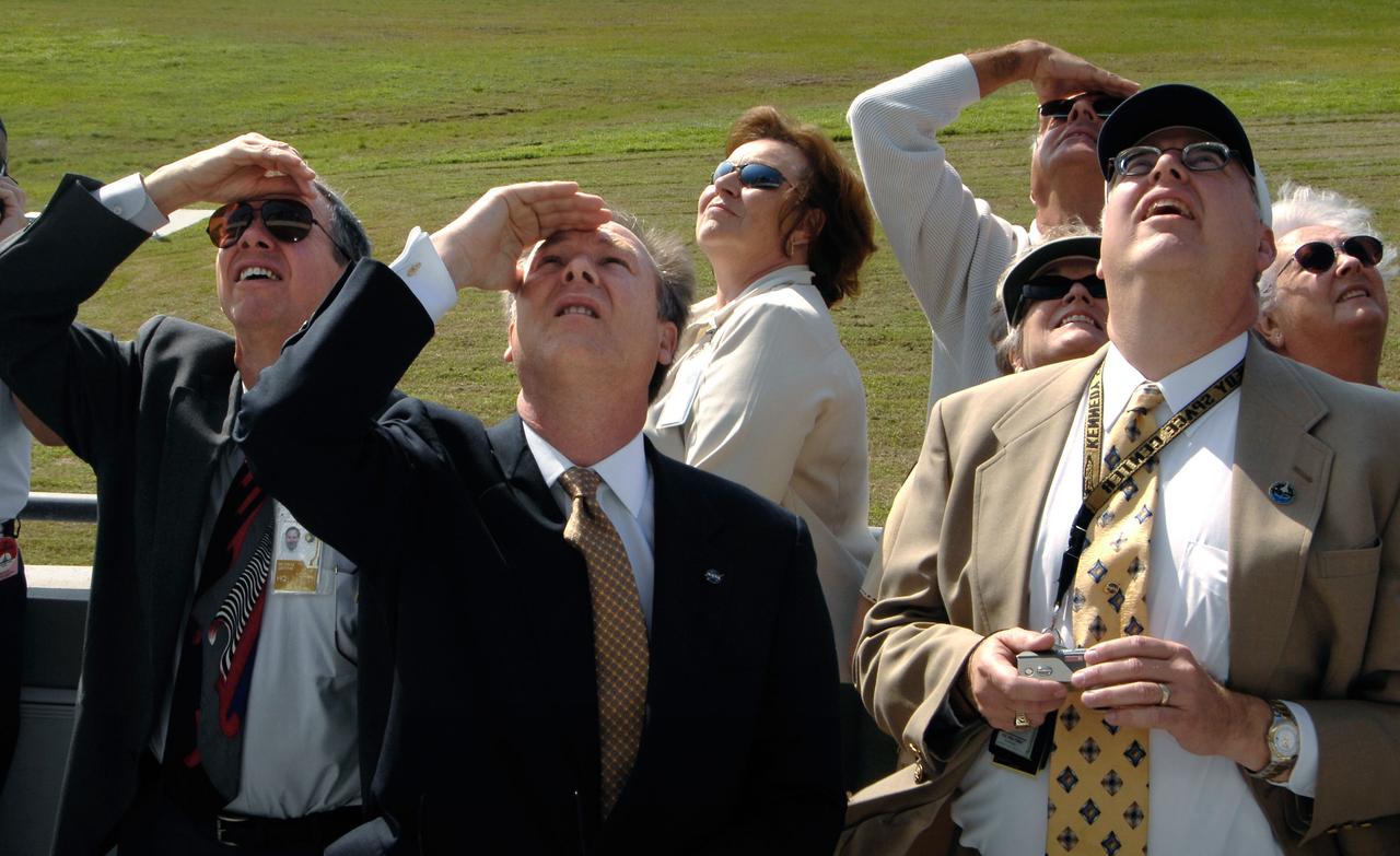 (left to right) NASA Administrator Michael Griffin, NASA Assistant Administrator for Public Affairs David Mould and NASA Space Shuttle Manager Wayne Hale watch as the space shuttle Discovery comes in for landing at NASA's Kennedy Space Center, Fla., completing the 15-day STS-120 mission to the International Space Station. Discovery landed at 1:01pm EST Wednesday after a mission that included on-orbit construction of the station with the installation of the Harmony Node 2 module and the relocation of the P6 truss.  Photo Credit: 'NASA/Bill Ingalls"