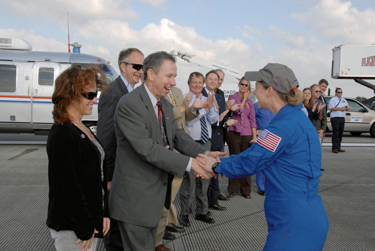 STS120-S-091 (7 Nov. 2007) --- NASA Administrator Mike Griffin and his wife Rebecca Griffin (left) greet astronaut Pam Melroy, STS-120 commander, at NASA's Kennedy Space Center. Behind Griffin is Associate Administrator for NASA Space Operations William Gerstenmaier. Melroy and the Space Shuttle Discovery crew completed the 15-day STS-120 mission, with an on-time landing at 1:01:16 p.m. (EST). Wheel stop was at 1:02:07 p.m. Mission elapsed time was 15 days, 2 hours, 24 minutes and 2 seconds. The STS-120 crew continued the construction of the station with the installation of the Harmony Node 2 module and the relocation of the P6 truss.