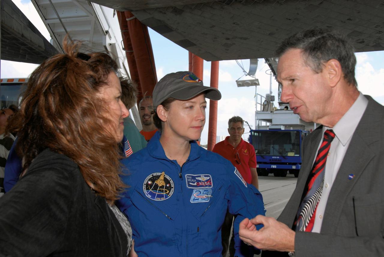 STS120-S-093 (7 Nov. 2007) --- Standing underneath Space Shuttle Discovery on the Shuttle Landing Facility at NASA's Kennedy Space Center, NASA Administrator Mike Griffin (right) talks with astronaut Pam Melroy (center), STS-120 commander, after the landing of the vehicle. At left is Rebecca Griffin, wife of the administrator. The Discovery crew completed the 15-day STS-120 mission, with an on-time landing at 1:01:16 p.m. (EST). Wheel stop was at 1:02:07 p.m. Mission elapsed time was 15 days, 2 hours, 24 minutes and 2 seconds. The STS-120 crew continued the construction of the station with the installation of the Harmony Node 2 module and the relocation of the P6 truss.