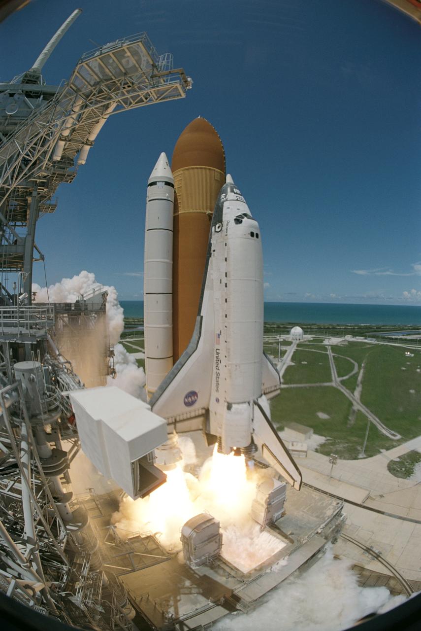 STS121-S-049 (4 July 2006) --- Captured on film by a remote camera equipped with a special "fish-eye" lens, the Space Shuttle Discovery and its seven-member crew launch at 2:38 p.m. (EDT) to begin the two-day journey to the International Space Station on the historic Return to Flight STS-121 mission. Discovery is slated to dock with the station at 10:52 a.m. (EDT) Thursday July 6, 2006. The shuttle made history as it was the first human-occupying spacecraft to launch on Independence Day. During the 12-day mission, the STS-121 crew of seven will test new equipment and procedures to improve shuttle safety, as well as deliver supplies and make repairs to the space station