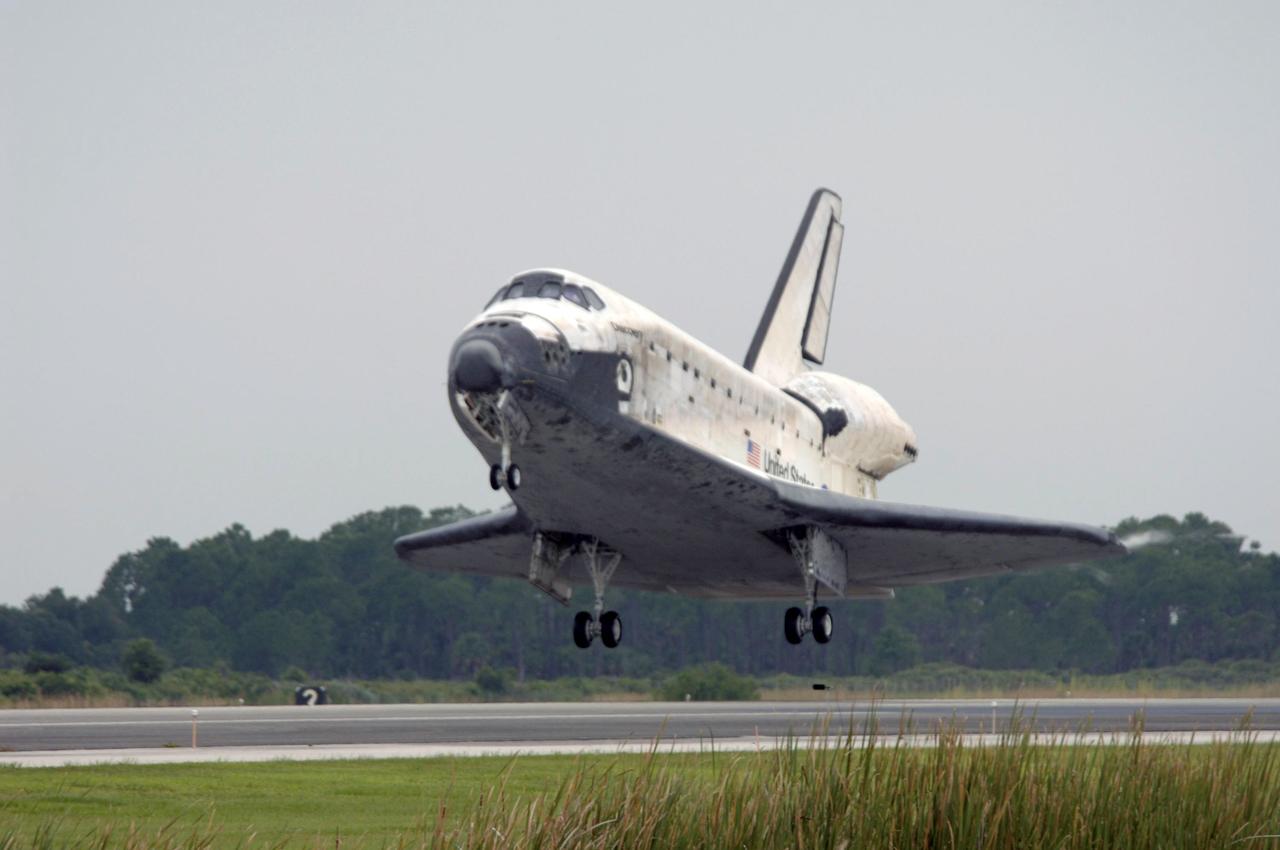 STS121-S-053 (17 July 2006) --- Space Shuttle Discovery's main landing gear is about to touch down on runway 15 at Kennedy Space Center's Shuttle Landing Facility at 9:14 a.m. (EDT) on July 17, 2006. Onboard were astronauts Steven W. Lindsey, commander; Mark E. Kelly, pilot; Piers J. Sellers, Michael E. Fossum, Lisa M. Nowak and Stephanie D. Wilson, all mission specialists. During the nearly 13-day mission, the STS-121 crew tested new equipment and procedures to improve shuttle safety, and delivered supplies and made repairs to the International Space Station.