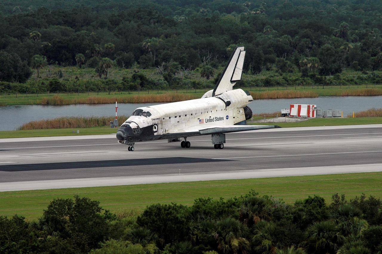 STS121-S-057 (17 July 2006) --- Space Shuttle Discovery slows to a stop after landing on runway 15 at Kennedy Space Center's Shuttle Landing Facility at 9:14 a.m. (EDT) on July 17, 2006. Onboard were astronauts Steven W. Lindsey, commander; Mark E. Kelly, pilot; Piers J. Sellers, Michael E. Fossum, Lisa M. Nowak and Stephanie D. Wilson, all mission specialists. During the nearly 13-day mission, the STS-121 crew tested new equipment and procedures to improve shuttle safety, and delivered supplies and made repairs to the International Space Station.