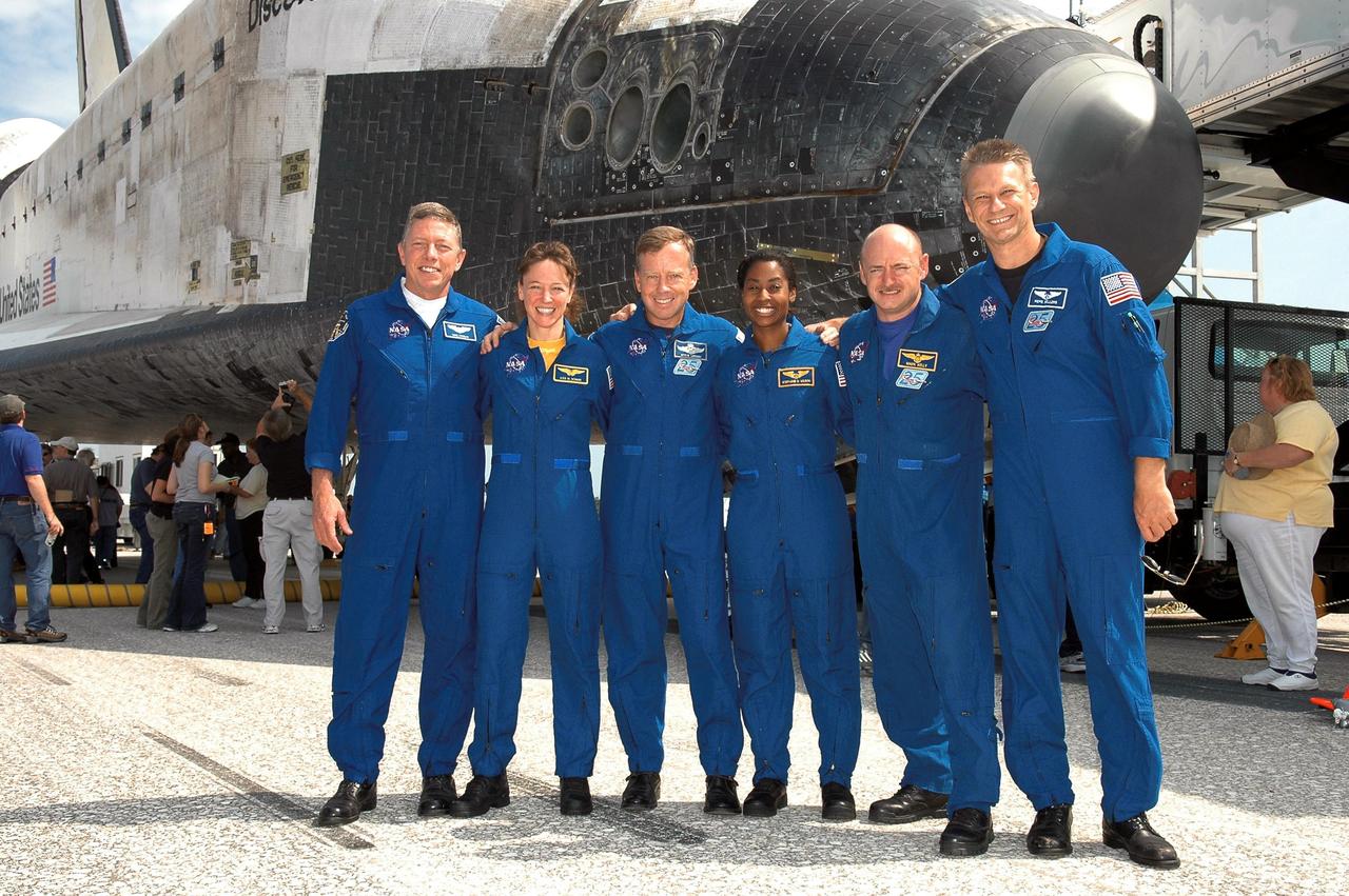 STS121-S-059 (17 July 2006) --- The STS-121 crew poses in front of the   Space Shuttle Discovery near the landing facility at Kennedy Space Center following NASA's second Return to Flight mission. From left to right are astronauts Michael E. Fossum, Lisa M. Nowak, Steven W. Lindsey, Stephanie D. Wilson, Mark E. Kelly and Piers J. Sellers.