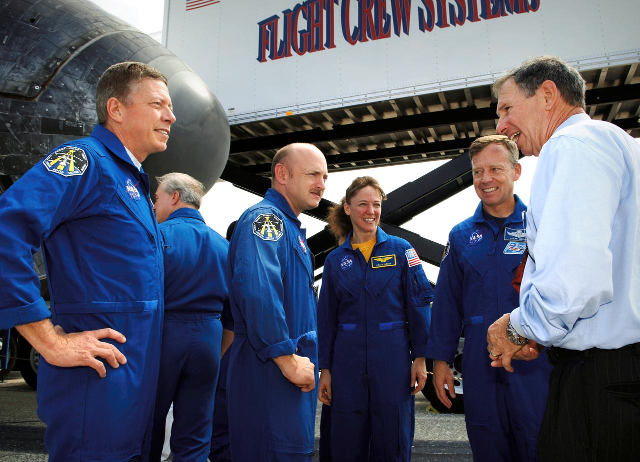 STS121-S-065 (17 July 2006)  --- Dr. Michael Griffin (right), NASA Administrator, talks with STS-121 crew members (L to R) Michael E. Fossum, mission specialist; Mark E. Kelly, pilot; Lisa M. Nowak, mission specialist; and Steven W. Lindsey, commander, after the landing of the Space Shuttle Discovery and conclusion of mission STS-121. The crew of seven tested new equipment and procedures to improve shuttle safety, as well as deliver supplies and make repairs to the International Space Station. Photo Credit: NASA/Bill Ingalls