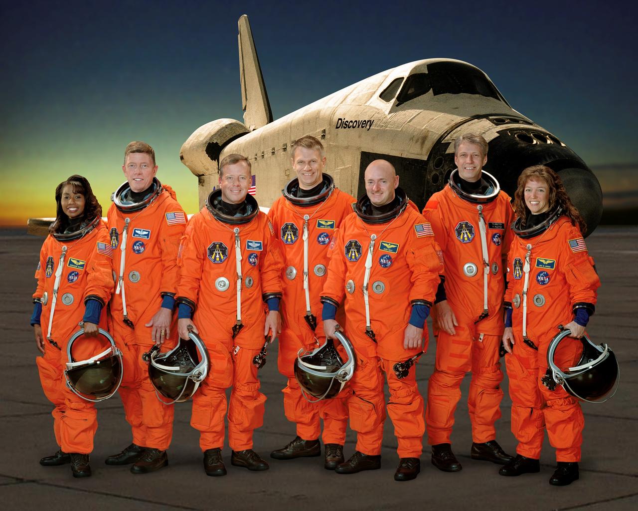 STS121-S-002 (5 April 2006) --- These seven astronauts take a break from training to pose for the STS-121 crew portrait. From the left are astronauts Stephanie D. Wilson, Michael E. Fossum, both mission specialists; Steven W. Lindsey, commander; Piers J. Sellers, mission specialist; Mark E. Kelly, pilot; European Space Agency (ESA) astronaut Thomas Reiter of Germany; and Lisa M. Nowak, both mission specialists. The crewmembers are attired in training versions of their shuttle launch and entry suit.