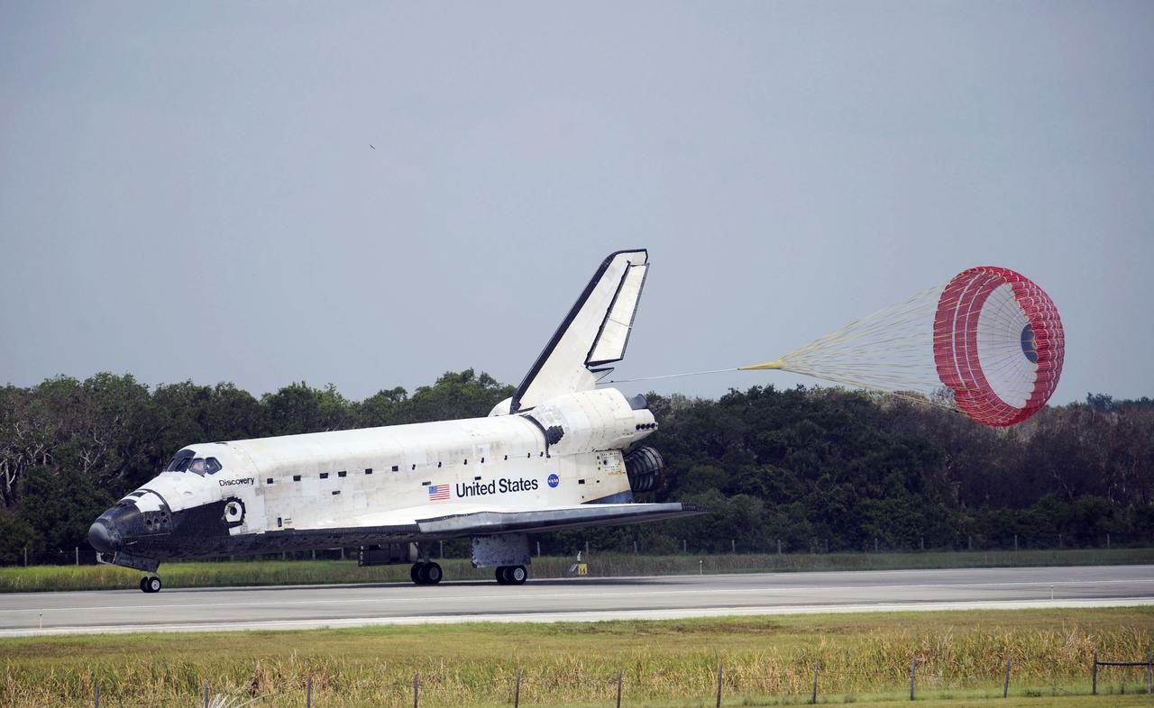 STS124-S-049 (14 June 2008) --- Space Shuttle Discovery's drag chute is deployed as the spacecraft rolls toward wheels stop on runway 15 of the Shuttle Landing Facility at NASA's Kennedy Space Center, concluding the 14-day STS-124 mission to the International Space Station. Onboard are NASA astronauts Mark Kelly, commander; Ken Ham, pilot; Mike Fossum, Ron Garan, Karen Nyberg, Garrett Reisman and Japan Aerospace Exploration Agency astronaut Akihiko Hoshide, all mission specialists. The main landing gear touched down at 11:15:19 a.m. (EDT) on June 14, 2008. The nose landing gear touched down at 11:15:30 a.m. and wheel stop was at 11:16:19 a.m. During the mission, Discovery's crew installed the Japan Aerospace Exploration Agency's large Kibo laboratory and its remote manipulator system leaving a larger space station and one with increased science capabilities.