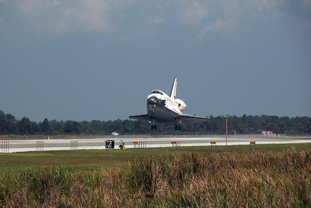 STS124-S-050 (14 June 2008) --- Space Shuttle Discovery touches down on runway 15 of the Shuttle Landing Facility at NASA's Kennedy Space Center, concluding the 14-day STS-124 mission to the International Space Station. Onboard are NASA astronauts Mark Kelly, commander; Ken Ham, pilot; Mike Fossum, Ron Garan, Karen Nyberg, Garrett Reisman and Japan Aerospace Exploration Agency astronaut Akihiko Hoshide, all mission specialists. The main landing gear touched down at 11:15:19 a.m. (EDT) on June 14, 2008. The nose landing gear touched down at 11:15:30 a.m. and wheel stop was at 11:16:19 a.m. During the mission, Discovery's crew installed the Japan Aerospace Exploration Agency's large Kibo laboratory and its remote manipulator system leaving a larger space station and one with increased science capabilities.