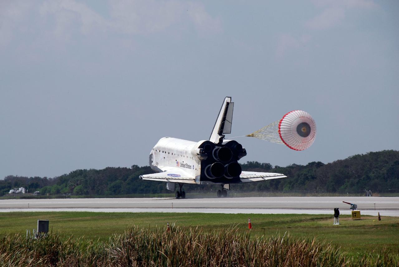 STS124-S-051 (14 June 2008) --- Space Shuttle Discovery's drag chute is deployed as the spacecraft rolls toward wheels stop on runway 15 of the Shuttle Landing Facility at NASA's Kennedy Space Center, concluding the 14-day STS-124 mission to the International Space Station. Onboard are NASA astronauts Mark Kelly, commander; Ken Ham, pilot; Mike Fossum, Ron Garan, Karen Nyberg, Garrett Reisman and Japan Aerospace Exploration Agency astronaut Akihiko Hoshide, all mission specialists. The main landing gear touched down at 11:15:19 a.m. (EDT) on June 14, 2008. The nose landing gear touched down at 11:15:30 a.m. and wheel stop was at 11:16:19 a.m. During the mission, Discovery's crew installed the Japan Aerospace Exploration Agency's large Kibo laboratory and its remote manipulator system leaving a larger space station and one with increased science capabilities.