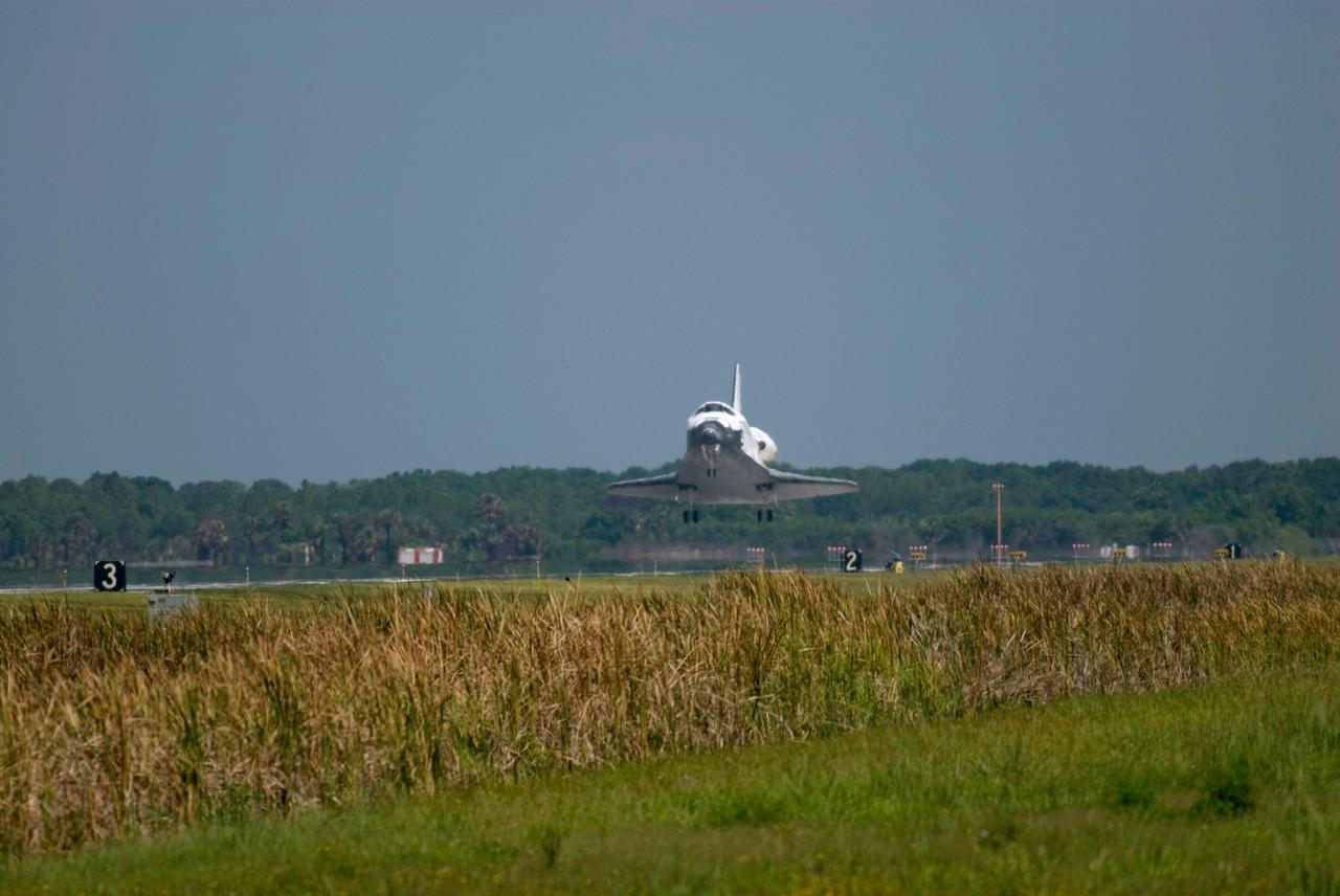 STS124-S-059 (14 June 2008) --- Space Shuttle Discovery is moments away from touchdown on runway 15 of the Shuttle Landing Facility at NASA's Kennedy Space Center, concluding the 14-day STS-124 mission to the International Space Station. Onboard are NASA astronauts Mark Kelly, commander; Ken Ham, pilot; Mike Fossum, Ron Garan, Karen Nyberg, Garrett Reisman and Japan Aerospace Exploration Agency astronaut Akihiko Hoshide, all mission specialists. The main landing gear touched down at 11:15:19 a.m. (EDT) on June 14, 2008. The nose landing gear touched down at 11:15:30 a.m. and wheel stop was at 11:16:19 a.m. During the mission, Discovery's crew installed the Japan Aerospace Exploration Agency's large Kibo laboratory and its remote manipulator system leaving a larger space station and one with increased science capabilities.