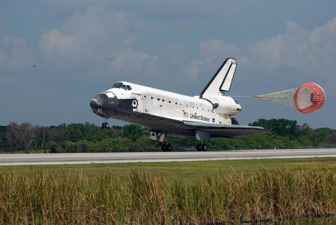 STS124-S-061 (14 June 2008) --- Space Shuttle Discovery's drag chute is deployed as the spacecraft rolls toward wheels stop on runway 15 of the Shuttle Landing Facility at NASA's Kennedy Space Center, concluding the 14-day STS-124 mission to the International Space Station. Onboard are NASA astronauts Mark Kelly, commander; Ken Ham, pilot; Mike Fossum, Ron Garan, Karen Nyberg, Garrett Reisman and Japan Aerospace Exploration Agency astronaut Akihiko Hoshide, all mission specialists. The main landing gear touched down at 11:15:19 a.m. (EDT) on June 14, 2008. The nose landing gear touched down at 11:15:30 a.m. and wheel stop was at 11:16:19 a.m. During the mission, Discovery's crew installed the Japan Aerospace Exploration Agency's large Kibo laboratory and its remote manipulator system leaving a larger space station and one with increased science capabilities.
