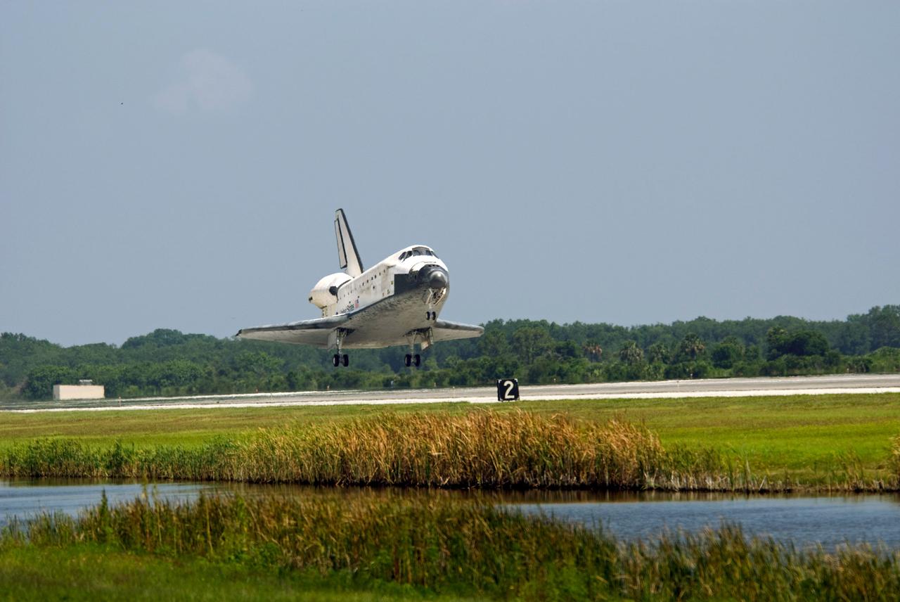 STS124-S-063 (14 June 2008) --- Space Shuttle Discovery is moments away from touchdown on runway 15 of the Shuttle Landing Facility at NASA's Kennedy Space Center, concluding the 14-day STS-124 mission to the International Space Station. Onboard are NASA astronauts Mark Kelly, commander; Ken Ham, pilot; Mike Fossum, Ron Garan, Karen Nyberg, Garrett Reisman and Japan Aerospace Exploration Agency astronaut Akihiko Hoshide, all mission specialists. The main landing gear touched down at 11:15:19 a.m. (EDT) on June 14, 2008. The nose landing gear touched down at 11:15:30 a.m. and wheel stop was at 11:16:19 a.m. During the mission, Discovery's crew installed the Japan Aerospace Exploration Agency's large Kibo laboratory and its remote manipulator system leaving a larger space station and one with increased science capabilities.