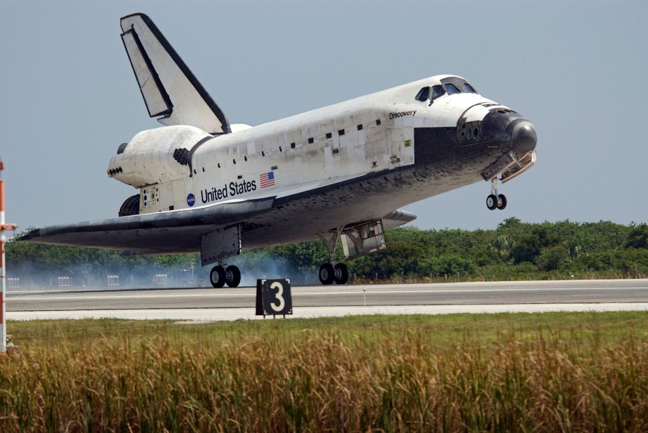 STS124-S-065 (14 June 2008) --- Space Shuttle Discovery touches down on runway 15 of the Shuttle Landing Facility at NASA's Kennedy Space Center, concluding the 14-day STS-124 mission to the International Space Station. Onboard are NASA astronauts Mark Kelly, commander; Ken Ham, pilot; Mike Fossum, Ron Garan, Karen Nyberg, Garrett Reisman and Japan Aerospace Exploration Agency astronaut Akihiko Hoshide, all mission specialists. The main landing gear touched down at 11:15:19 a.m. (EDT) on June 14, 2008. The nose landing gear touched down at 11:15:30 a.m. and wheel stop was at 11:16:19 a.m. During the mission, Discovery's crew installed the Japan Aerospace Exploration Agency's large Kibo laboratory and its remote manipulator system leaving a larger space station and one with increased science capabilities.