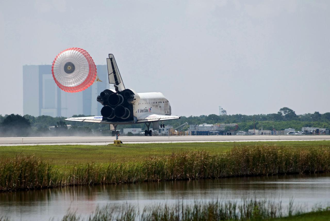 STS124-S-068 (14 June 2008) --- Space Shuttle Discovery's drag chute is deployed as the spacecraft rolls toward wheels stop on runway 15 of the Shuttle Landing Facility at NASA's Kennedy Space Center, concluding the 14-day STS-124 mission to the International Space Station. Onboard are NASA astronauts Mark Kelly, commander; Ken Ham, pilot; Mike Fossum, Ron Garan, Karen Nyberg, Garrett Reisman and Japan Aerospace Exploration Agency astronaut Akihiko Hoshide, all mission specialists. The main landing gear touched down at 11:15:19 a.m. (EDT) on June 14, 2008. The nose landing gear touched down at 11:15:30 a.m. and wheel stop was at 11:16:19 a.m. During the mission, Discovery's crew installed the Japan Aerospace Exploration Agency's large Kibo laboratory and its remote manipulator system leaving a larger space station and one with increased science capabilities.