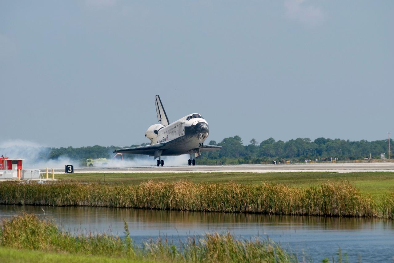 STS124-S-069 (14 June 2008) --- Space Shuttle Discovery touches down on runway 15 of the Shuttle Landing Facility at NASA's Kennedy Space Center, concluding the 14-day STS-124 mission to the International Space Station. Onboard are NASA astronauts Mark Kelly, commander; Ken Ham, pilot; Mike Fossum, Ron Garan, Karen Nyberg, Garrett Reisman and Japan Aerospace Exploration Agency astronaut Akihiko Hoshide, all mission specialists. The main landing gear touched down at 11:15:19 a.m. (EDT) on June 14, 2008. The nose landing gear touched down at 11:15:30 a.m. and wheel stop was at 11:16:19 a.m. During the mission, Discovery's crew installed the Japan Aerospace Exploration Agency's large Kibo laboratory and its remote manipulator system leaving a larger space station and one with increased science capabilities.