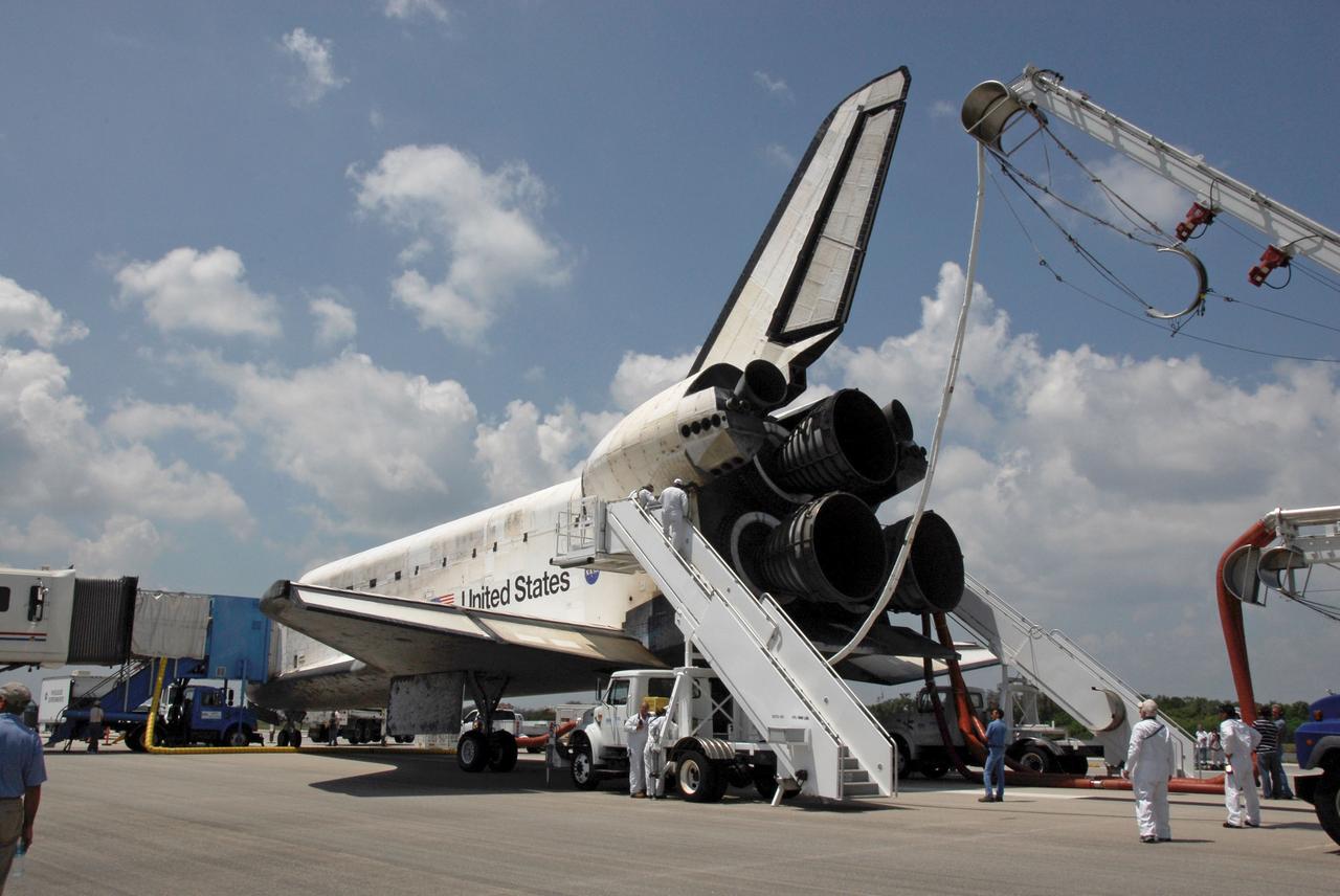 STS124-S-071 (14 June 2008) --- After landing on runway 15 at NASA's Kennedy Space Center, space shuttle Discovery is purged -- providing cool and humidified air conditioning to the payload bay and other cavities to remove any residual explosive or toxic fumes -- while still on the runway. Cooling transfer to ground services occurs at about the same time, allowing onboard cooling to be shut down. When it is determined that the area in and around the orbiter is safe, the crew prepares for departure from the orbiter. The main landing gear touched down at 11:15:19 a.m. (EDT) on June 14, 2008. The nose landing gear touched down at 11:15:30 a.m. and wheel stop was at 11:16:19 a.m. During the mission, Discovery's crew installed the Japan Aerospace Exploration Agency's large Kibo laboratory and its remote manipulator system leaving a larger space station and one with increased science capabilities.