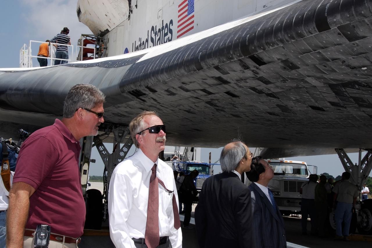 STS124-S-072 (14 June 2008) --- After Space Shuttle Discovery's landing on runway 15 at NASA's Kennedy Space Center (KSC), NASA VIPs take a close look at the orbiter. From the left are KSC Director Bill Parsons and Bill Gerstenmaier, NASA associate administrator for Space Operations. At right are the Japan Aerospace Exploration Agency's Director of Program Management and Integration Yuichi Yamaura and Vice President Kaoru Mamiya. Discovery's landing ended the STS-124 mission, a 14-day flight to the International Space Station. The main landing gear touched down at 11:15:19 a.m. (EDT) on June 14, 2008. The nose landing gear touched down at 11:15:30 a.m. and wheel stop was at 11:16:19 a.m. During the mission, Discovery's crew installed the Japan Aerospace Exploration Agency's large Kibo laboratory and its remote manipulator system leaving a larger space station and one with increased science capabilities.