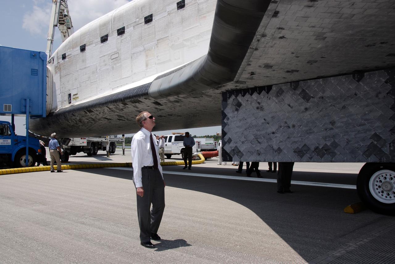 STS124-S-074 (14 June 2008) --- Bill Gerstenmaier, NASA associate administrator for Space Operations, looks at the thermal protection system tiles on the underside of Space Shuttle Discovery, whose landing ended the STS-124 mission, a 14-day flight to the International Space Station. The main landing gear touched down at 11:15:19 a.m. (EDT) on June 14, 2008. The nose landing gear touched down at 11:15:30 a.m. and wheel stop was at 11:16:19 a.m. During the mission, Discovery's crew installed the Japan Aerospace Exploration Agency's large Kibo laboratory and its remote manipulator system leaving a larger space station and one with increased science capabilities.