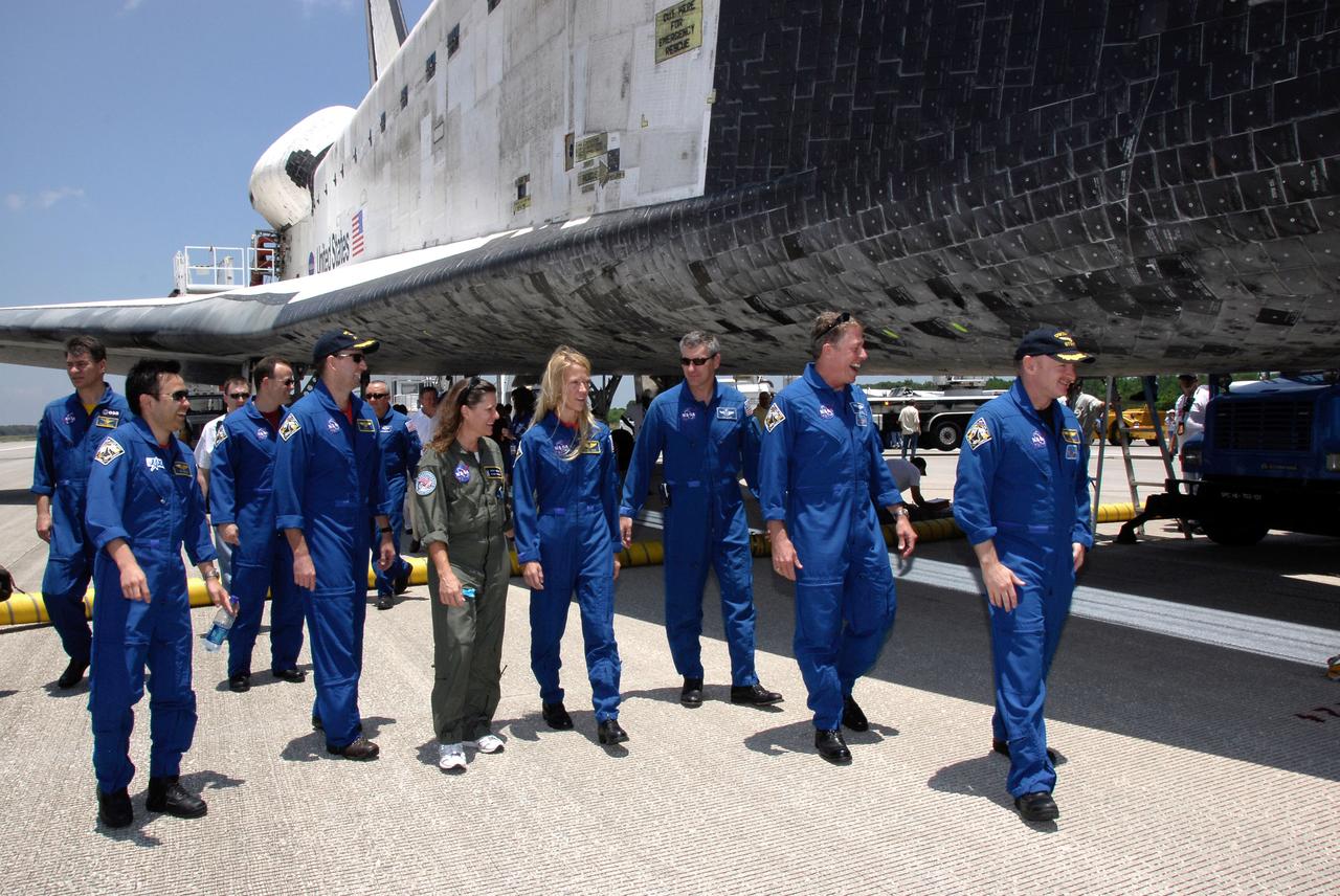 STS124-S-077 (14 June 2008) --- The STS-124 crewmembers finish their traditional walk-around Space Shuttle Discovery after landing on runway 15 at NASA's Kennedy Space Center, to end a 14-day mission to the International Space Station. At left are Japan Aerospace Exploration Agency astronaut Akihiko Hoshide, NASA astronauts Ron Garan, both mission specialists; and Ken Ham, pilot. At center is NASA astronaut Karen Nyberg, mission specialist. At right are NASA astronauts Mike Fossum, mission specialist, and Mark Kelly, commander. The STS-124 mission ended with Discovery's landing on runway 15 at NASA's Kennedy Space Center, ending a 14-day mission to the International Space Station. Discovery's main landing gear touched down at 11:15:19 a.m. (EDT) on June 14, 2008. The nose landing gear touched down at 11:15:30 a.m. and wheel stop was at 11:16:19 a.m. During the mission, Discovery's crew installed the Japan Aerospace Exploration Agency's large Kibo laboratory and its remote manipulator system leaving a larger space station and one with increased science capabilities.