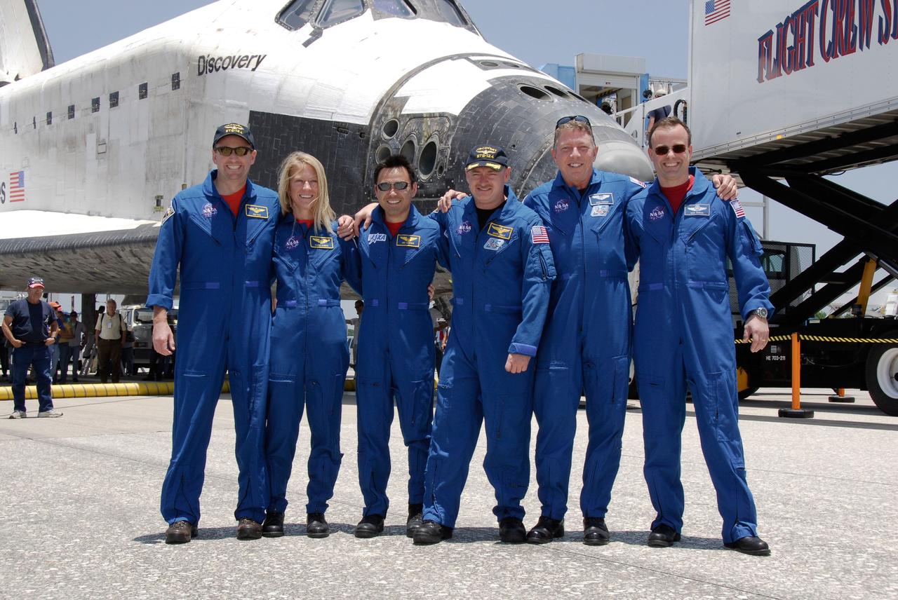 STS124-S-079 (14 June 2008) --- The STS-124 mission crew pose for a group photo before heading to crew quarters after their successful landing aboard Space Shuttle Discovery on runway 15 at NASA's Kennedy Space Center. The landing ended a 14-day mission to the International Space Station. From left are NASA astronauts Ken Ham, pilot; Karen Nyberg and Japan Aerospace Exploration Agency astronaut Akihiko Hoshide, both mission specialists; NASA astronauts Mark Kelly, commander; Mike Fossum and Ron Garan, both mission specialists. Discovery's main landing gear touched down at 11:15:19 a.m. (EDT) on June 14, 2008. The nose landing gear touched down at 11:15:30 a.m. and wheel stop was at 11:16:19 a.m. During the mission, Discovery's crew installed the Japan Aerospace Exploration Agency's large Kibo laboratory and its remote manipulator system leaving a larger space station and one with increased science capabilities.