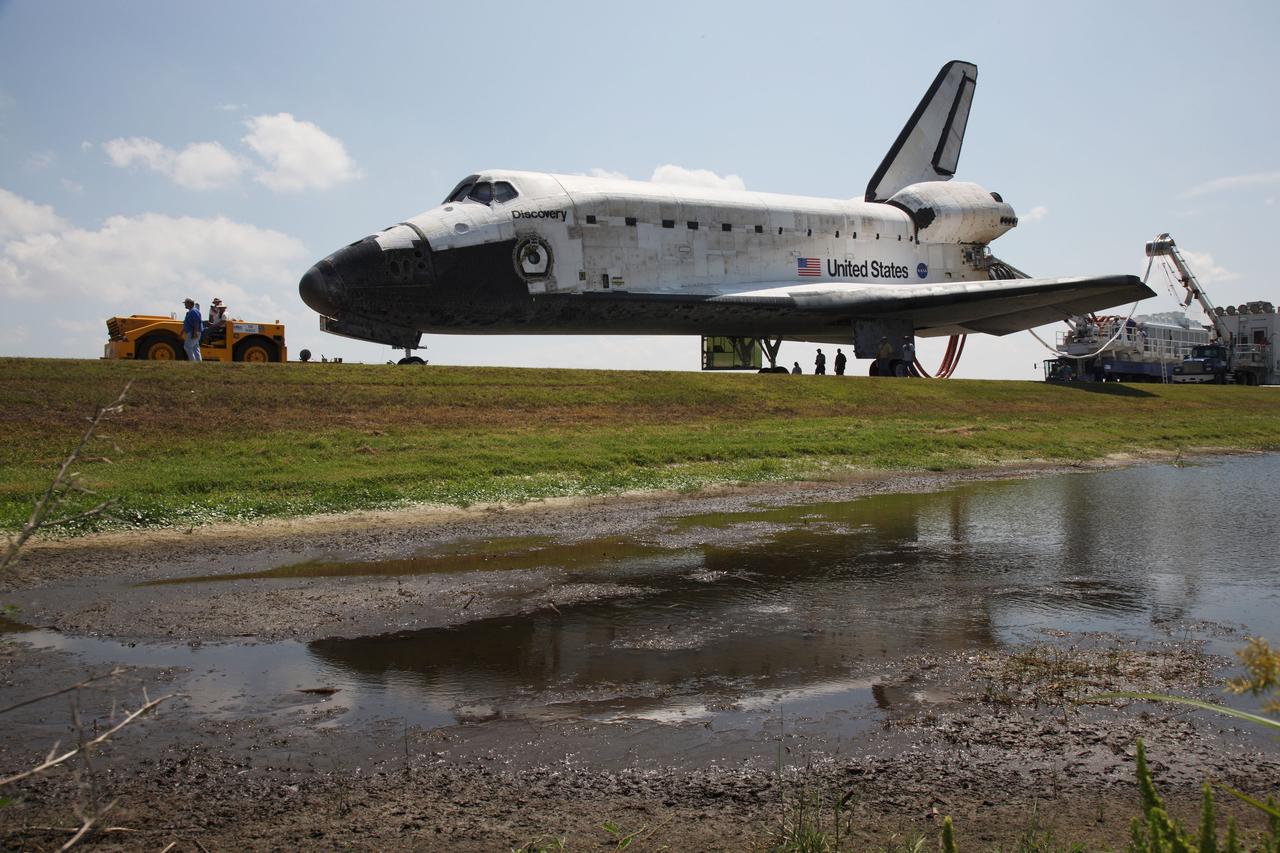 STS124-S-080 (14 June 2008) --- Space Shuttle Discovery is towed from the Shuttle Landing Facility at NASA's Kennedy Space Center. Discovery's landing ended the 14-day, STS-124 mission to the International Space Station. The STS-124 mission delivered the Japan Aerospace Exploration Agency's large Japanese Pressurized Module and its remote manipulator system to the International Space Station. The landing was on time at 11:15 a.m. (EDT) on June 14, 2008.