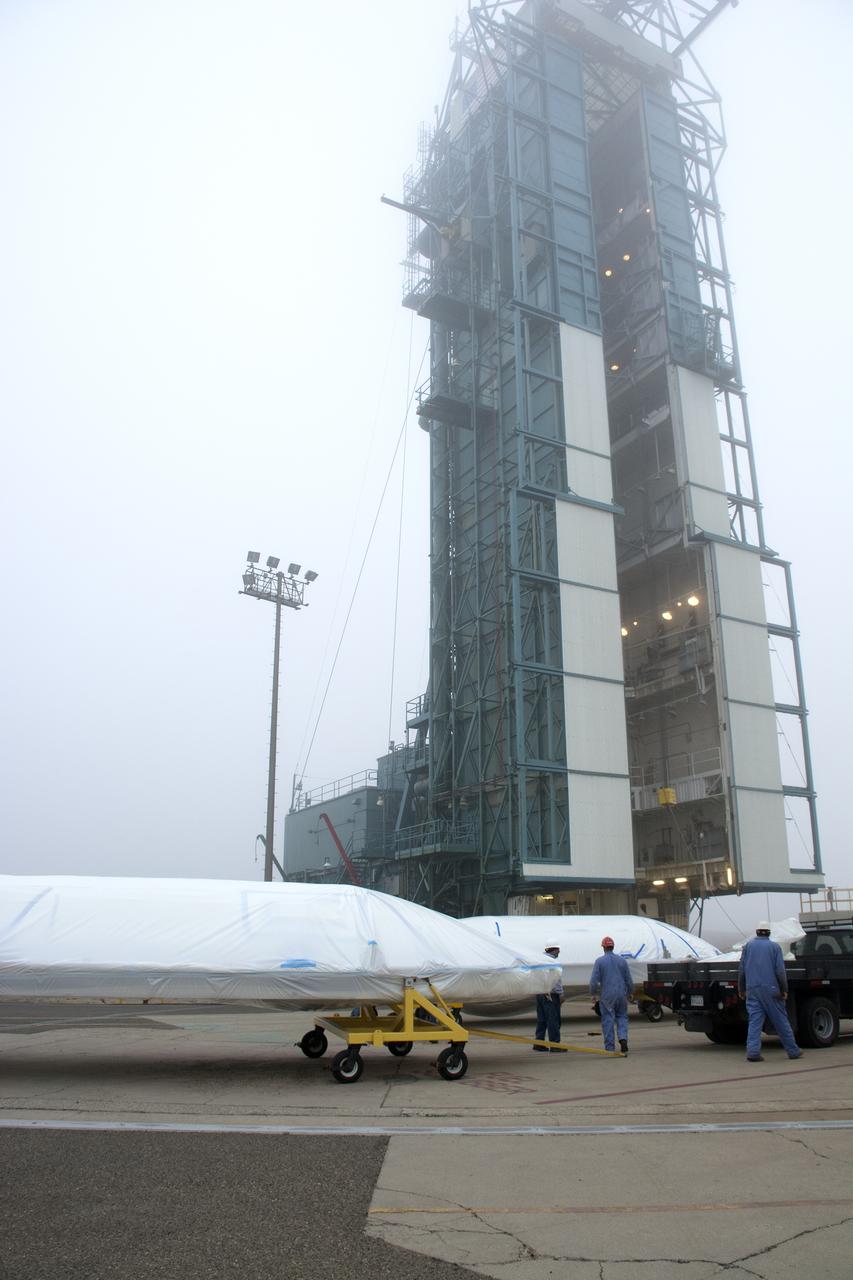 Bi-sector halves of the payload fairing for a United Launch Alliance Delta II rocket arrive at the mobile service tower on Space Launch Complex 2 at Vandenberg Air Force Base in California. Preparations are underway for launch of the Joint Polar Satellite System (JPSS-1) spacecraft in 2017. JPSS-1 is part of the next-generation environmental satellite system, a collaborative program between the National Oceanic and Atmospheric Administration (NOAA) and NASA. To learn more about JPSS-1, visit http://www.jpss.noaa.gov.