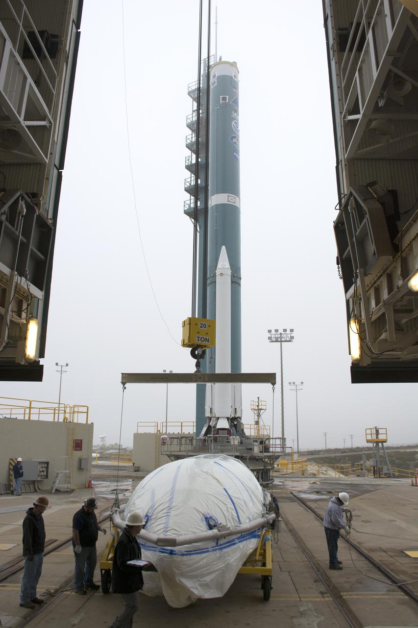 A bi-sector half of the payload fairing for a United Launch Alliance Delta II rocket is prepared for lifting into the mobile service tower on Space Launch Complex 2 at Vandenberg Air Force Base in California. Preparations are underway for launch of the Joint Polar Satellite System (JPSS-1) spacecraft in 2017. JPSS-1 is part of the next-generation environmental satellite system, a collaborative program between the National Oceanic and Atmospheric Administration (NOAA) and NASA. To learn more about JPSS-1, visit http://www.jpss.noaa.gov.