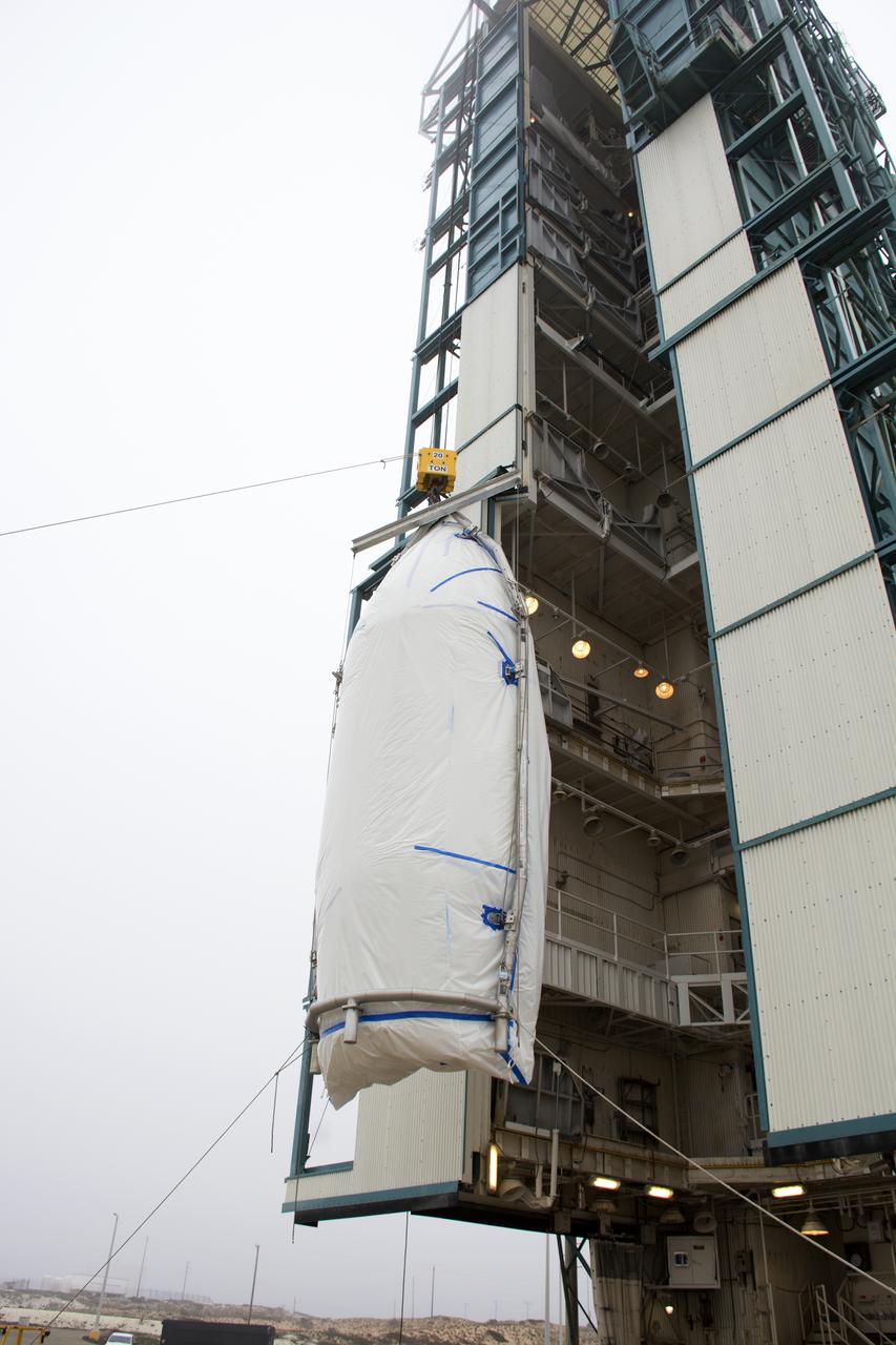 A bi-sector half of the payload fairing for a United Launch Alliance Delta II rocket is lifted up the side of the mobile service tower on Space Launch Complex 2 at Vandenberg Air Force Base in California. Preparations are underway for launch of the Joint Polar Satellite System (JPSS-1) spacecraft in 2017. JPSS-1 is part of the next-generation environmental satellite system, a collaborative program between the National Oceanic and Atmospheric Administration (NOAA) and NASA. To learn more about JPSS-1, visit http://www.jpss.noaa.gov.