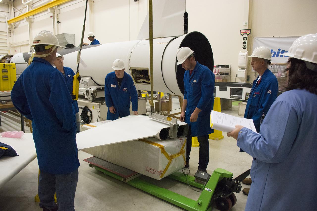 Technicians prepare one of the fins for installation on the Orbital ATK Pegasus XL rocket inside Building 1555 at Vandenberg Air Force Base in California. The fins will provide aerodynamic stability during flight. The rocket is being prepared at Vandenberg, and then will be transported to NASA’s Kennedy Space Center in Florida, attached to the Orbital ATK L-1011 carrier aircraft with NASA’s Cyclone Global Navigation Satellite System (CYGNSS) in its payload fairing. CYGNSS will launch on the Pegasus XL rocket from the Skid Strip at Cape Canaveral Air Force Station. CYGNSS will make frequent and accurate measurements of ocean surface winds throughout the life cycle of tropical storms and hurricanes. The data that CYGNSS provides will enable scientists to probe key air-sea interaction processes that take place near the core of storms, which are rapidly changing and play a critical role in the beginning and intensification of hurricanes.