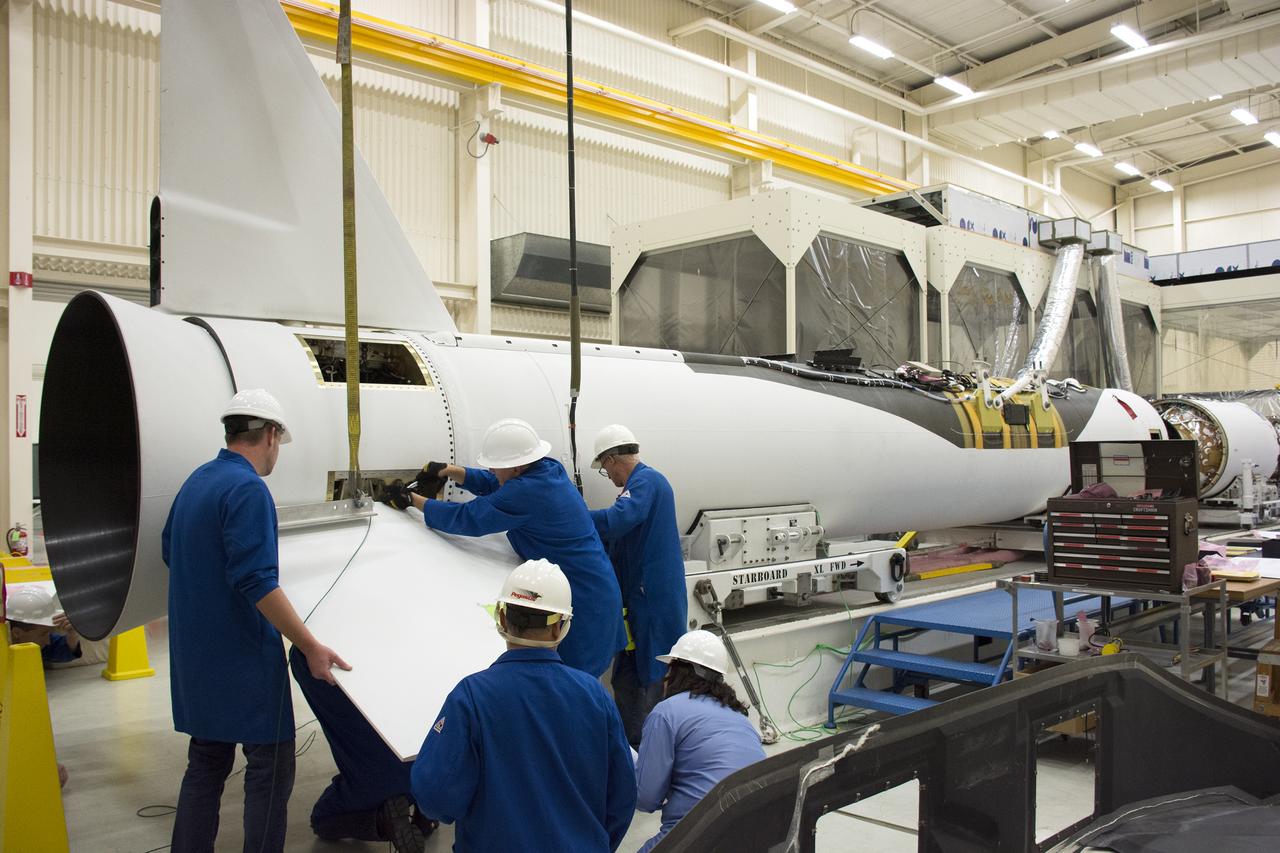 Technicians prepare to install one of the fins on the Orbital ATK Pegasus XL rocket inside Building 1555 at Vandenberg Air Force Base in California. The fins will provide aerodynamic stability during flight. The rocket is being prepared at Vandenberg, and then will be transported to NASA’s Kennedy Space Center in Florida attached to the Orbital ATK L-1011 carrier aircraft with NASA’s Cyclone Global Navigation Satellite System (CYGNSS) in its payload fairing. CYGNSS will launch on the Pegasus XL rocket from the Skid Strip at Cape Canaveral Air Force Station. CYGNSS will make frequent and accurate measurements of ocean surface winds throughout the life cycle of tropical storms and hurricanes. The data that CYGNSS provides will enable scientists to probe key air-sea interaction processes that take place near the core of storms, which are rapidly changing and play a critical role in the beginning and intensification of hurricanes.