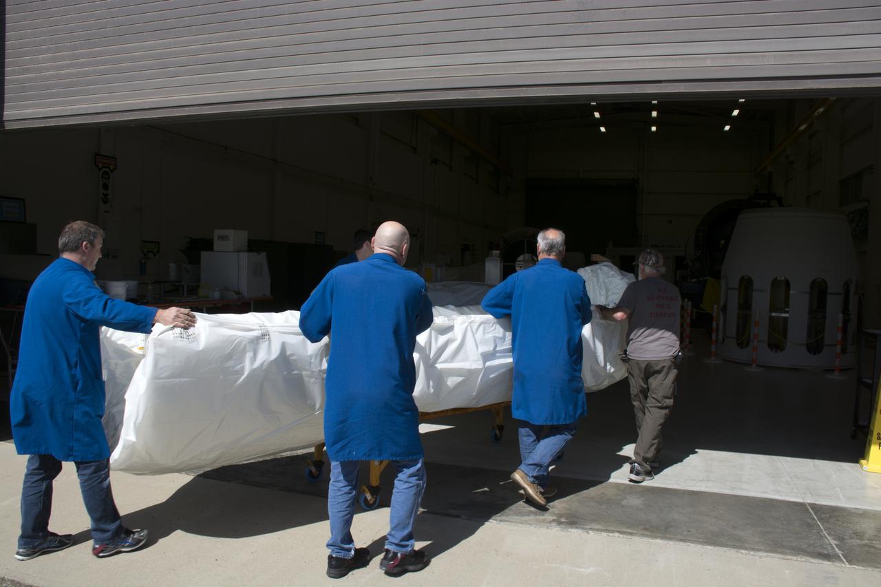 Technicians with Orbital ATK move the first half of the Pegasus payload fairing for NASA’s Cyclone Global Navigation Satellite System (CYGNSS) from into Building 1555 at Vandenberg Air Force Base in California. CYGNSS is being prepared at Vandenberg, and then will be transported to NASA’s Kennedy Space Center in Florida aboard the Orbital ATK Pegasus XL rocket which will be attached to the Orbital ATK L-1011 carrier aircraft. CYGNSS will launch on the Pegasus XL rocket from the Skid Strip at Cape Canaveral Air Force Station. CYGNSS will make frequent and accurate measurements of ocean surface winds throughout the life cycle of tropical storms and hurricanes. The data that CYGNSS provides will enable scientists to probe key air-sea interaction processes that take place near the core of storms, which are rapidly changing and play a critical role in the beginning and intensification of hurricanes. 
