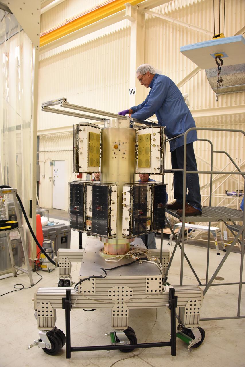 A technician with Orbital ATK checks the installation of the micro satellites on the deployment module for NASA’s Cyclone Global Navigation Satellite System (CYGNSS) in Building 1555 at Vandenberg Air Force Base in California. CYGNSS is being prepared at Vandenberg, and then will be transported to NASA’s Kennedy Space Center in Florida aboard the Orbital ATK Pegasus XL rocket which will be attached to the Orbital ATK L-1011 carrier aircraft. CYGNSS will launch on the Pegasus XL rocket from the Skid Strip at Cape Canaveral Air Force Station. CYGNSS will make frequent and accurate measurements of ocean surface winds throughout the life cycle of tropical storms and hurricanes. The data that CYGNSS provides will enable scientists to probe key air-sea interaction processes that take place near the core of storms, which are rapidly changing and play a critical role in the beginning and intensification of hurricanes. 